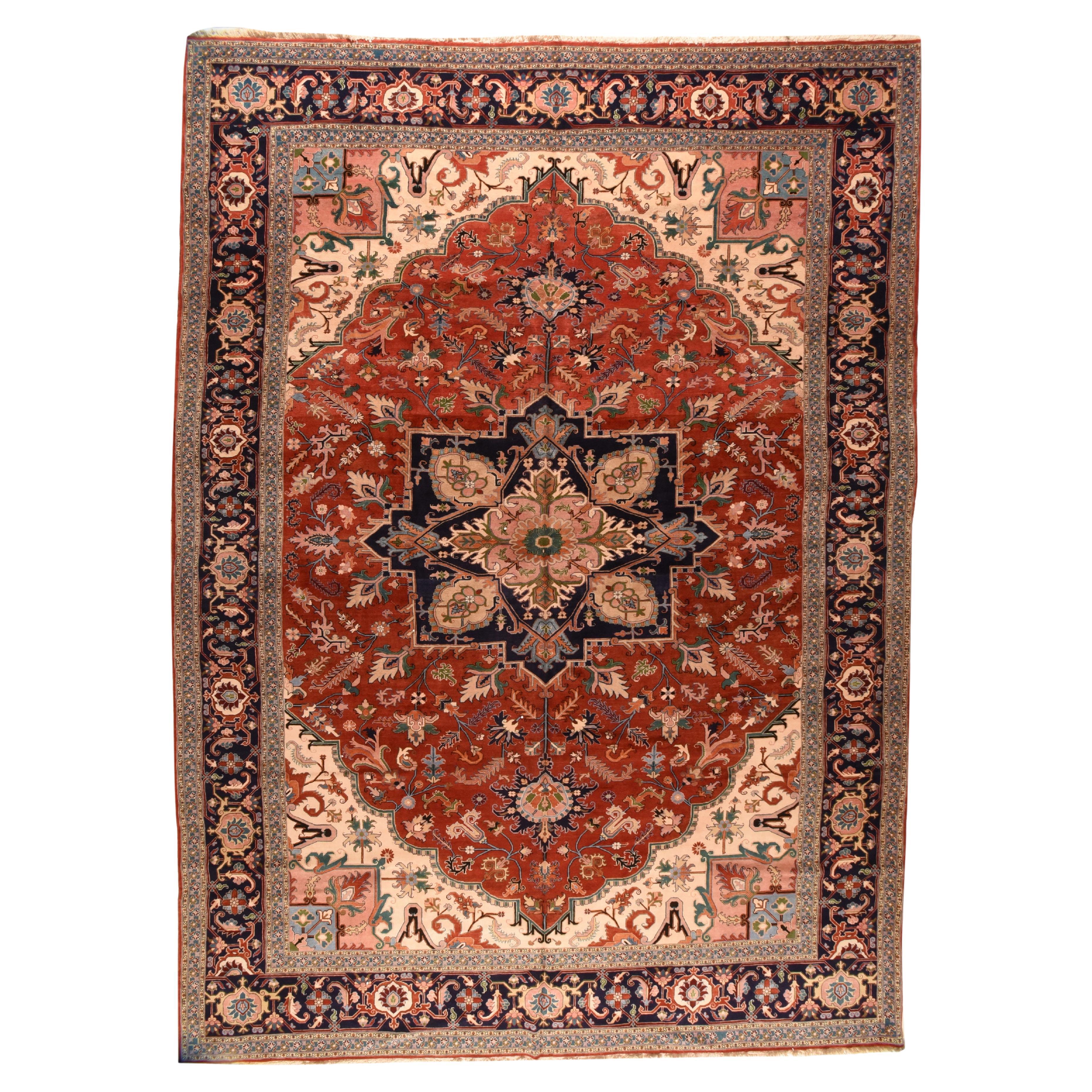 This rather well-drawn rustic carpet shows a scalloped red field centred by a four palmettes, octogramme navy medallion with ragged palmette pendants. Ivory conjoint corner pieces. Spiky leaves and flowers. Navy-black strip-style border with