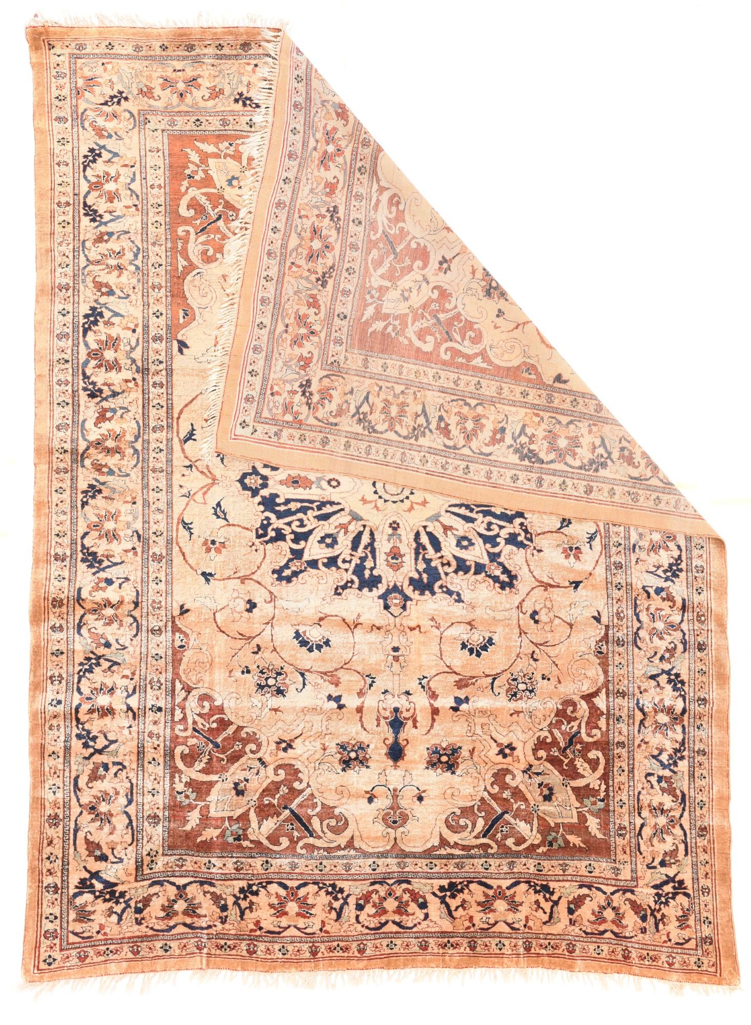 This very finely woven silk pile scatter shows a navy, straw and sand layered medallion controlling a spacious flowering arabesqueries, on a straw-sand ground, and set off by rust corners. Straw-sand main strip style border with palmettes, ragged