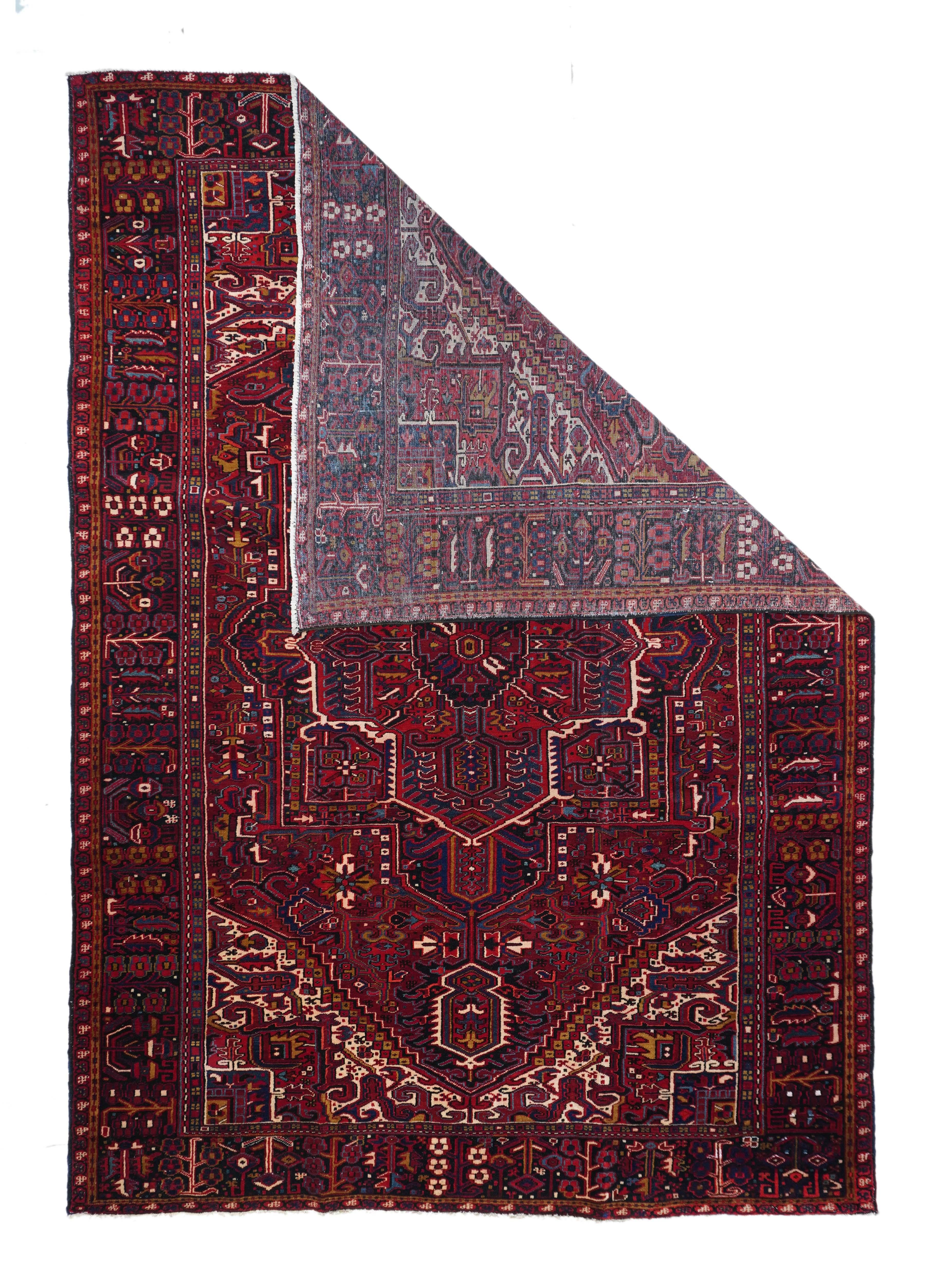 A post-WWII carpet with saturated palette, but a traditional design. Red field with red medallion and stepped navy sub-medallion. Layered ragged palmette navy pendants and well-packed minor devices. Ecru stepped corners with red square inner