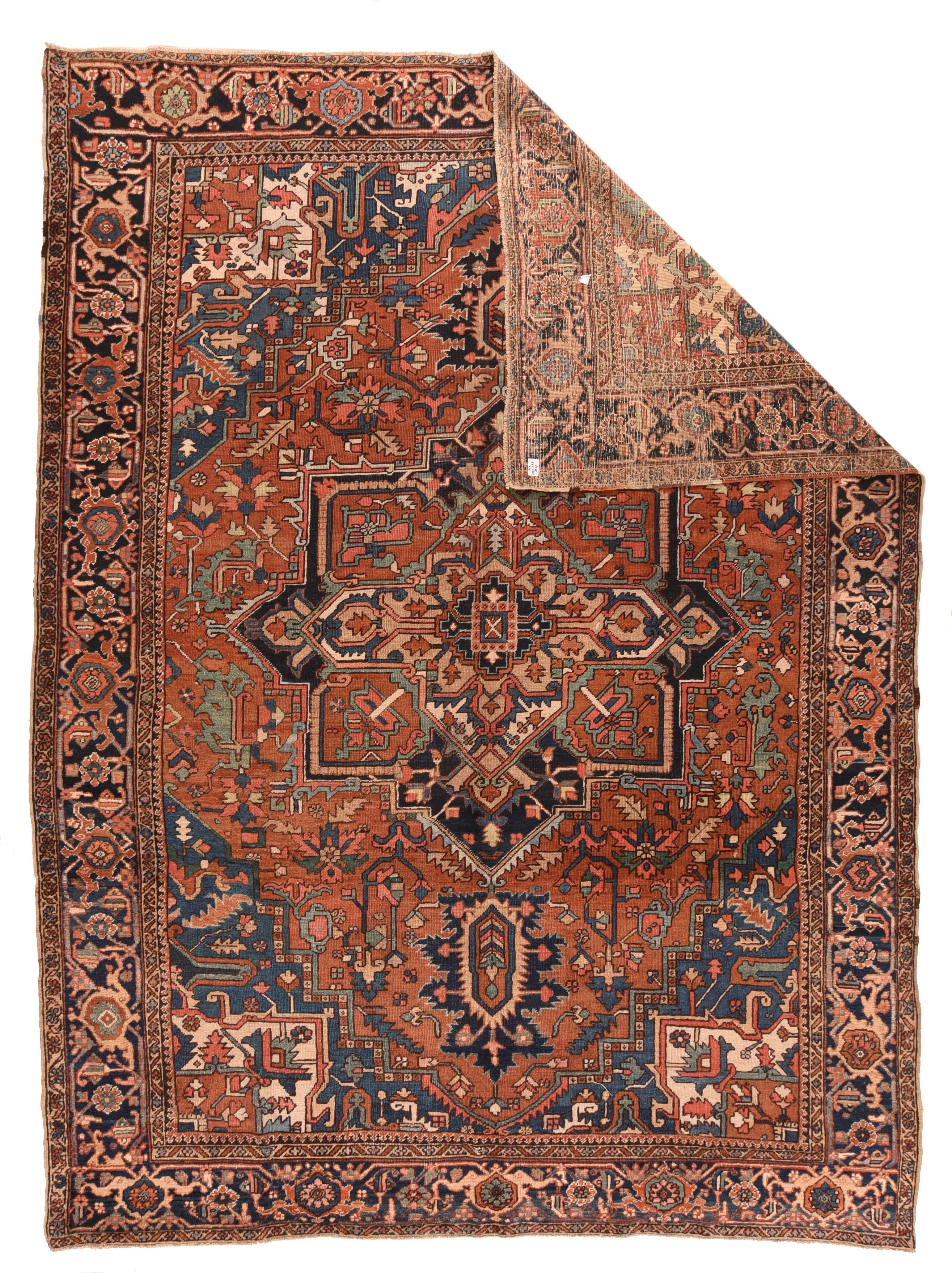 Moderately coarse, this broadly drawn NW Persian rural piece shows a navy and red octogramme medallion with bold navy ragged petal palmette pendants, on the slightly soft tomato red field displaying green leaves. The corners show ecru pointed