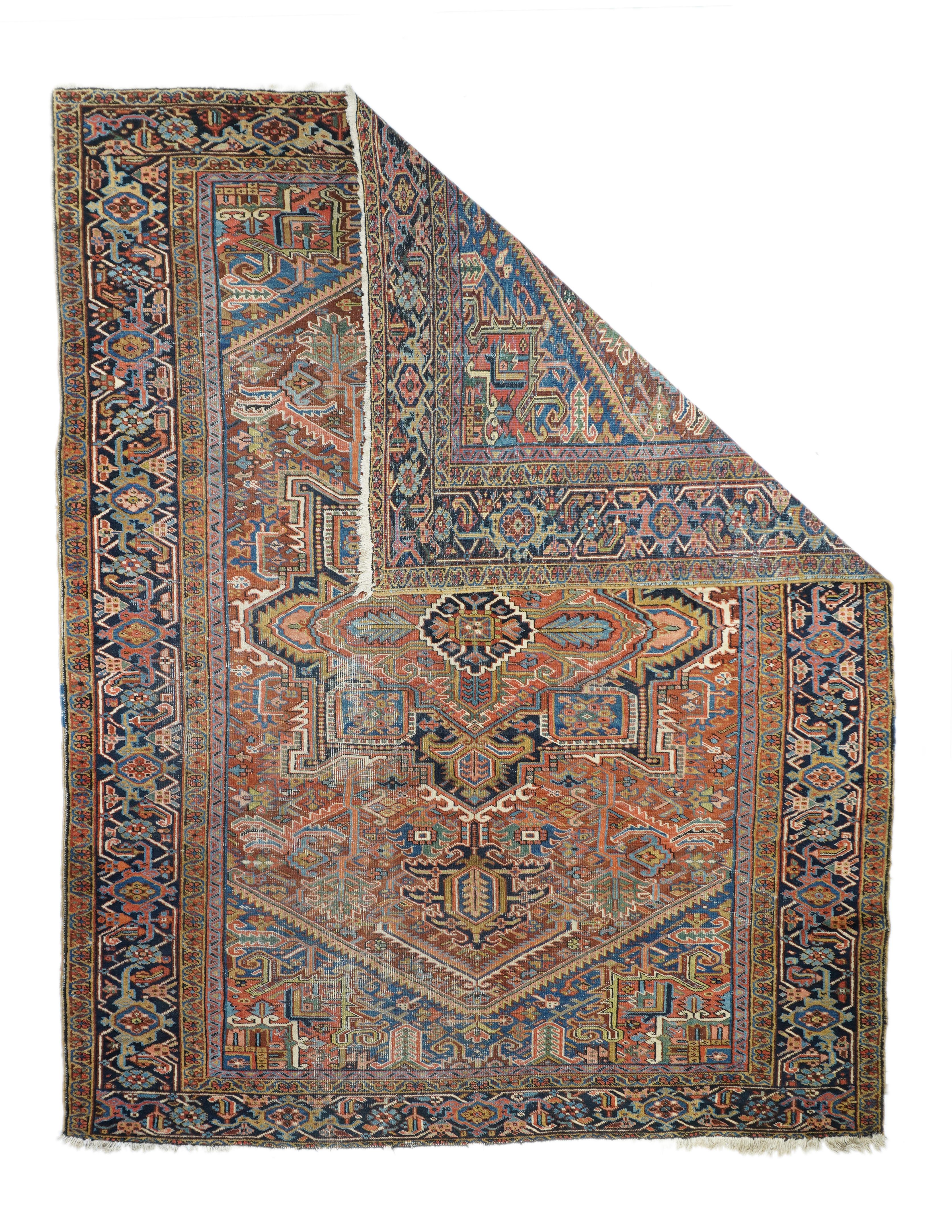 Moderately woven on cotton, this interwar NW  Persian village carpet features a red field well-filled with a navy octogramme medallion, ragged palmette pendants,  and various semi-geometric devices. Sawteeth and micro-stepping are very much in