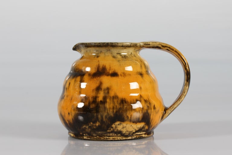 Art Deco ceramic jug or pitcher designed by Nils Kähler and made by Herman A. Kählers ceramic workshop in the 1930s.
The jug is decorated with glossy yellow speckled uranium glaze and has the signature HAK + Denmark

Measures: 
Height 13,5
