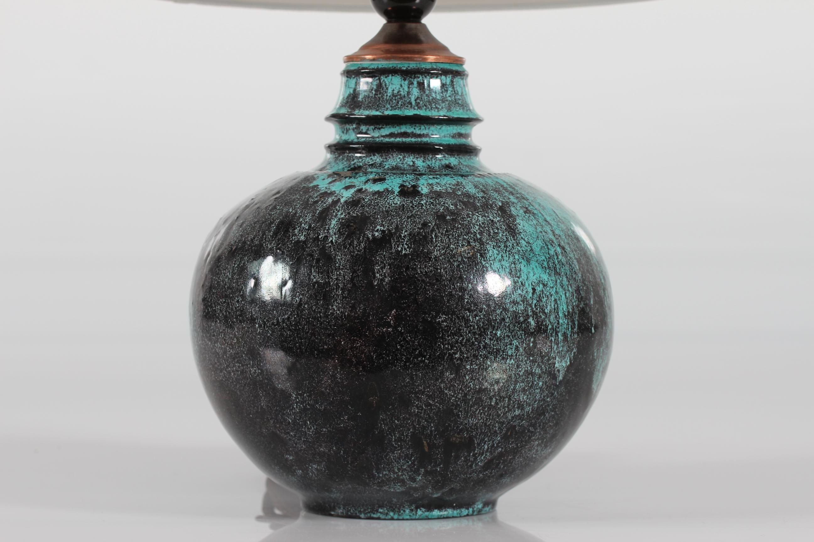 Rare Table lamp designed by Svend Hammershøi.
It's made by Herman A. Kählers ceramic workshop in Denmark in the 1930s

The artist Svend Hammershøi (1873-1948) was both a draftsman, a painter and a ceramist. 
He worked for Kähler from 1893 to