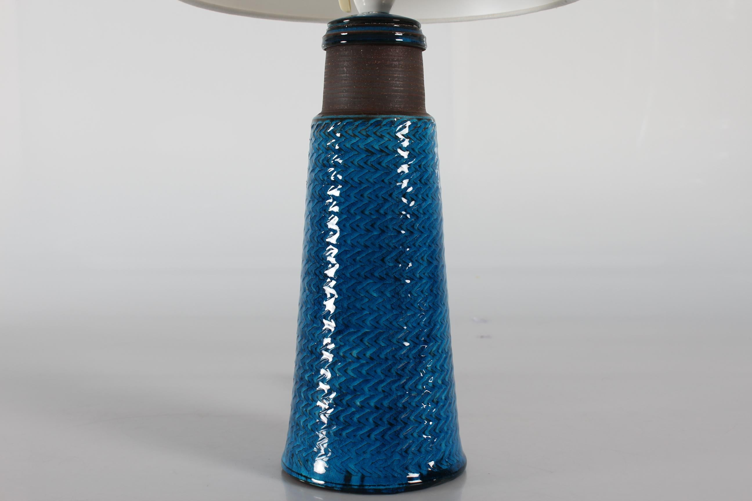 High table lamp by Nils Kähler made at Herman A. Kähler´s ceramic workshop in Denmark in the 1960s. 
This Lamp is a tall version.

Nils Kähler (1906-1979) was fourth generation of the family Kähler. He and his brother Herman Jørgen Kähler, who were