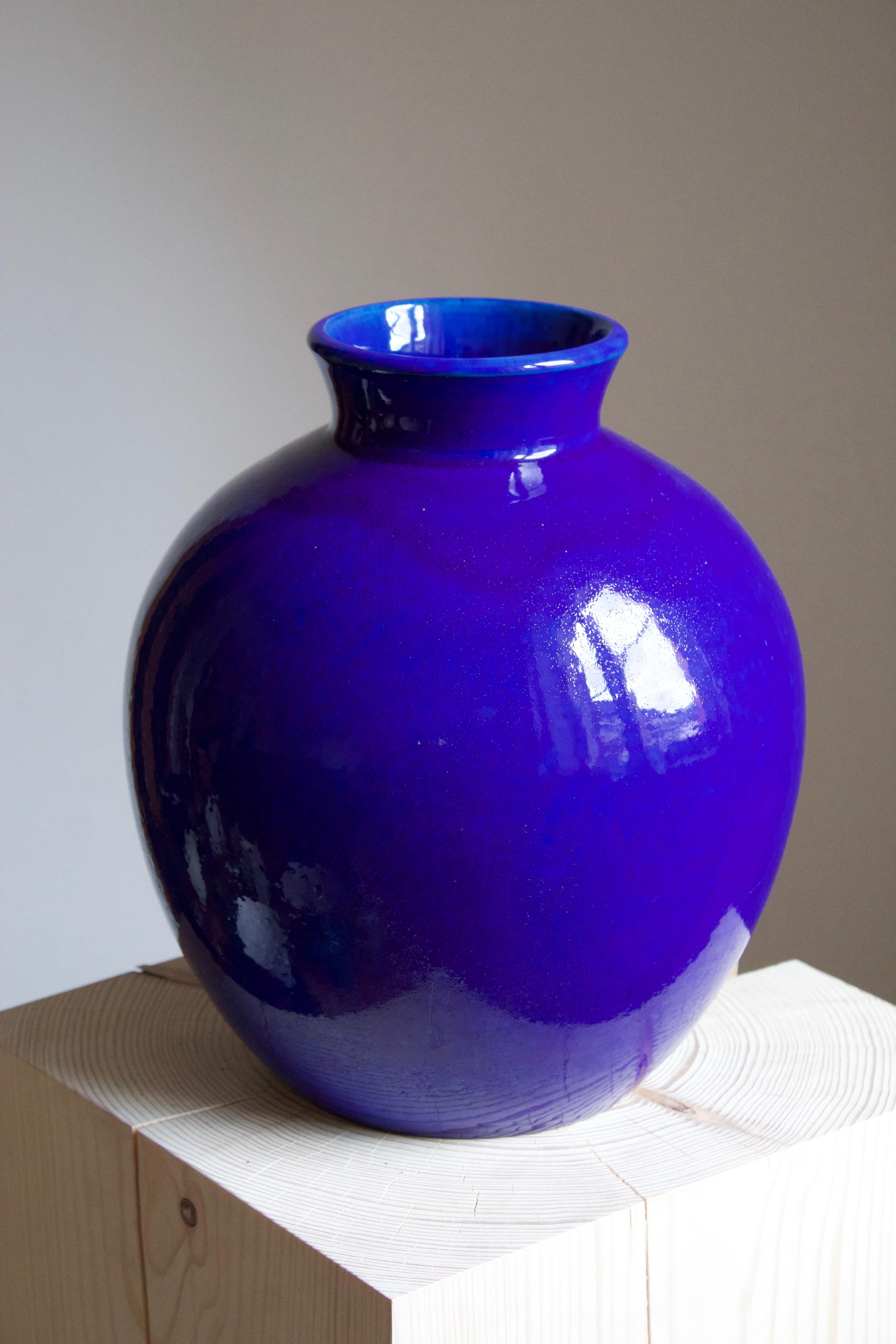 A very large vase. Designed and produced by Herman Kähler. Signed HAK. 

As is Kählers signature, the clay was sourced on the island of Bornholm. On this vase, an intense blue glaze has been applied.

Kähler is an important ceramicist known for