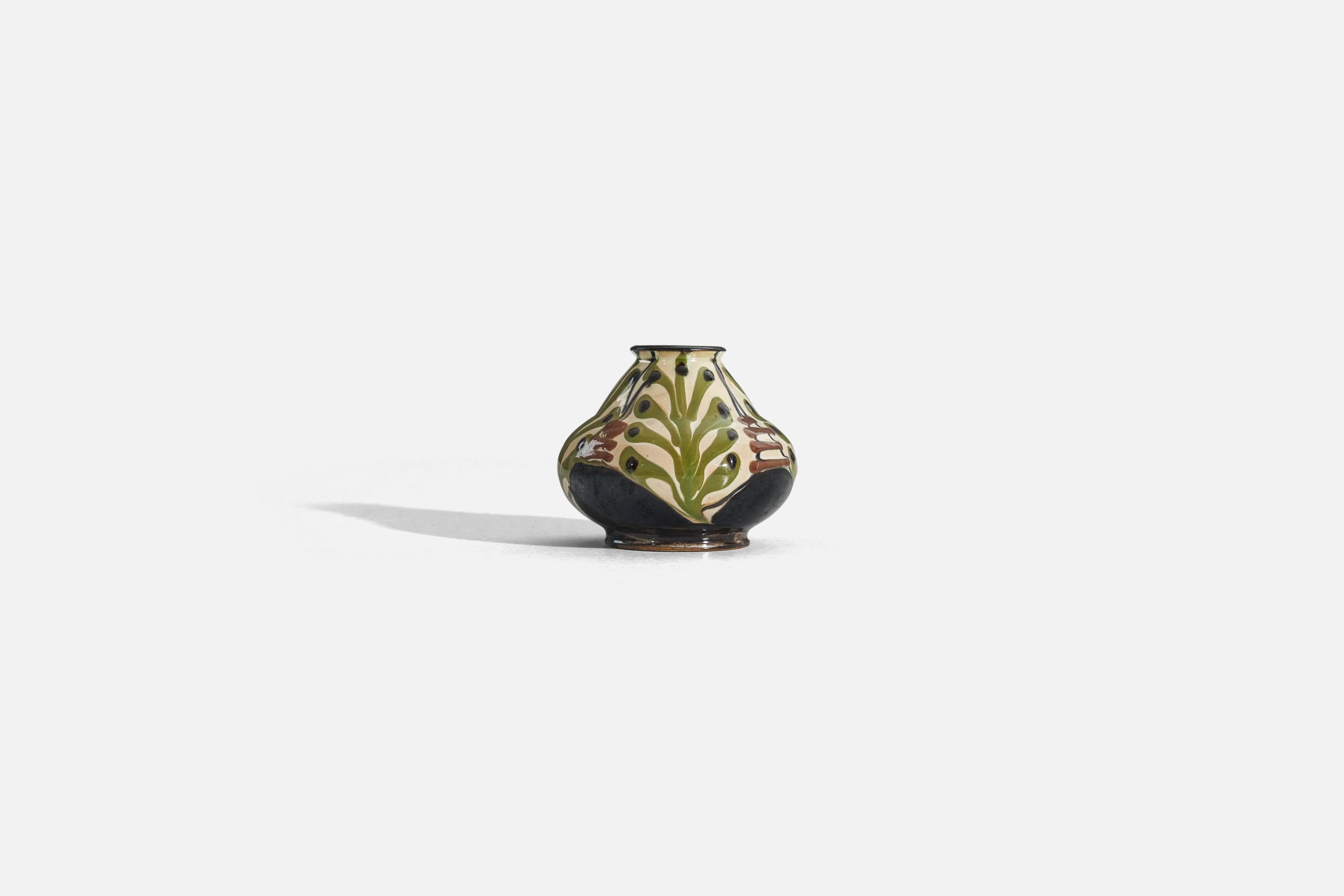 A glazed earthenware vase with a floral motif, designed and produced by Herman Kähler, Denmark, c. 1900.
 