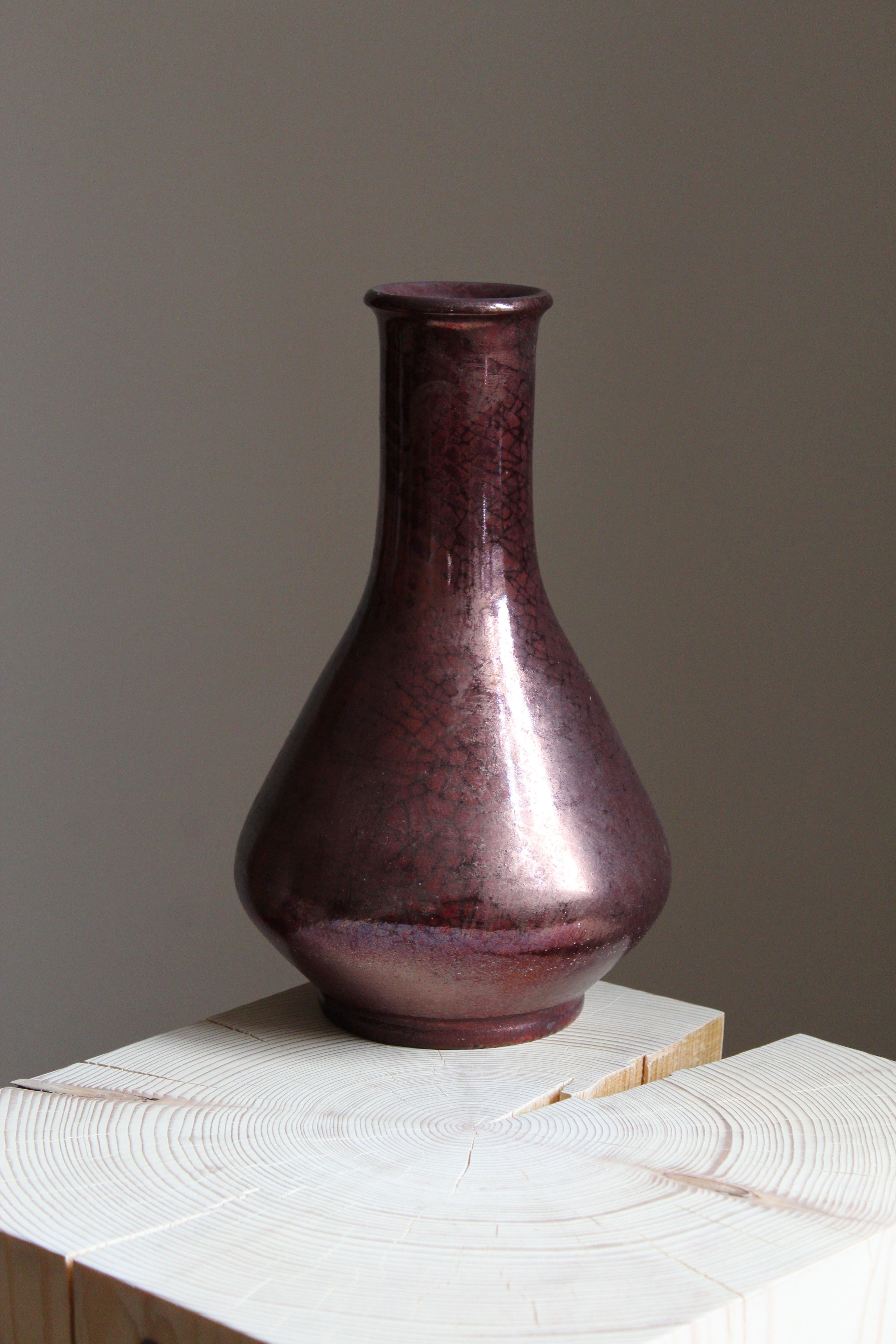 A sizable vase. Designed and produced by Herman Kähler. Signed HAK. 

As is Kählers signature, the clay was sourced on the island of Bornholm. On this vase, a highly complex and artistic oxblood glaze has been applied.

Kähler is an important