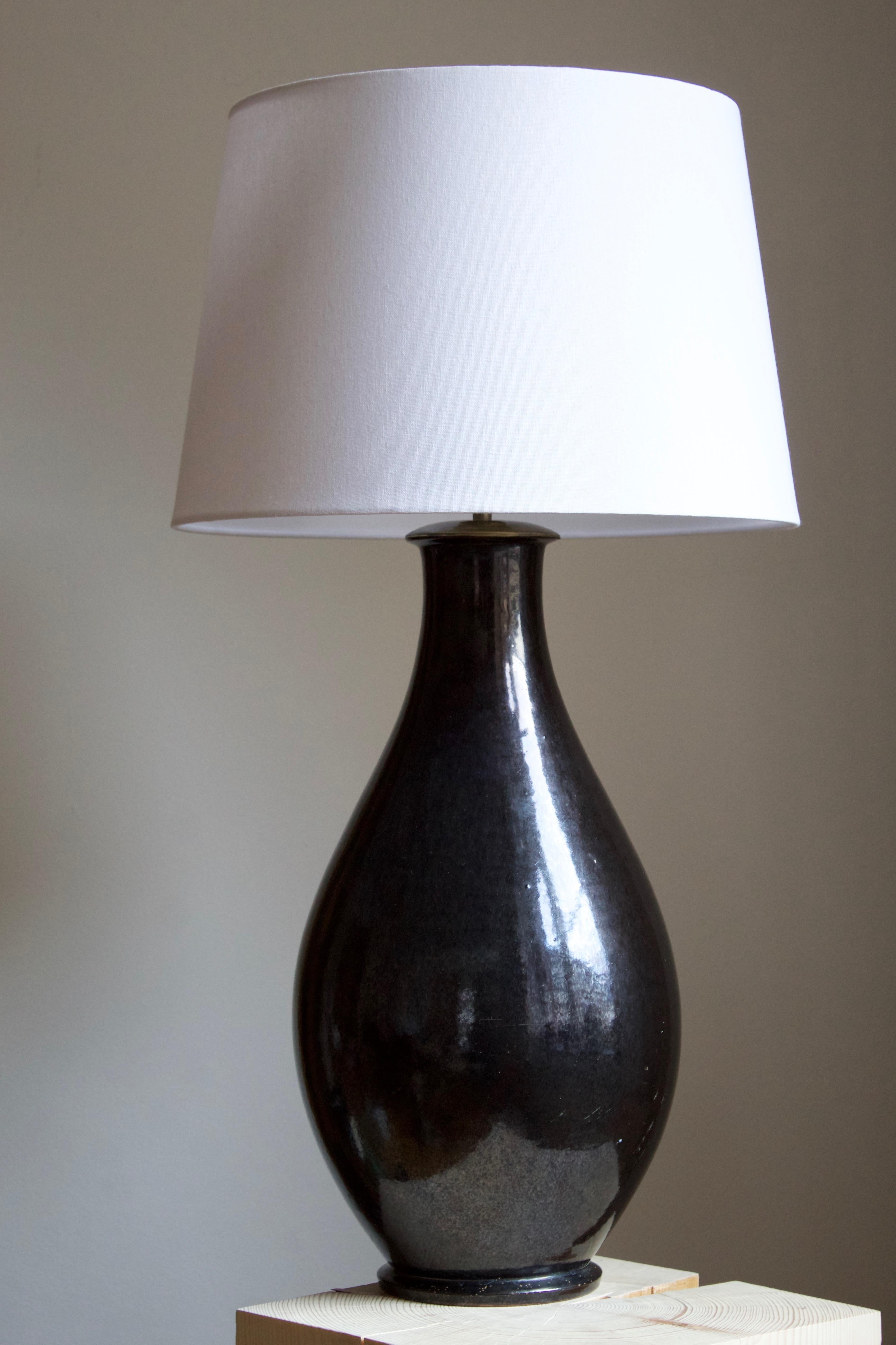 A large and impressive table lamp. Produced by Herman Kähler. Signed 