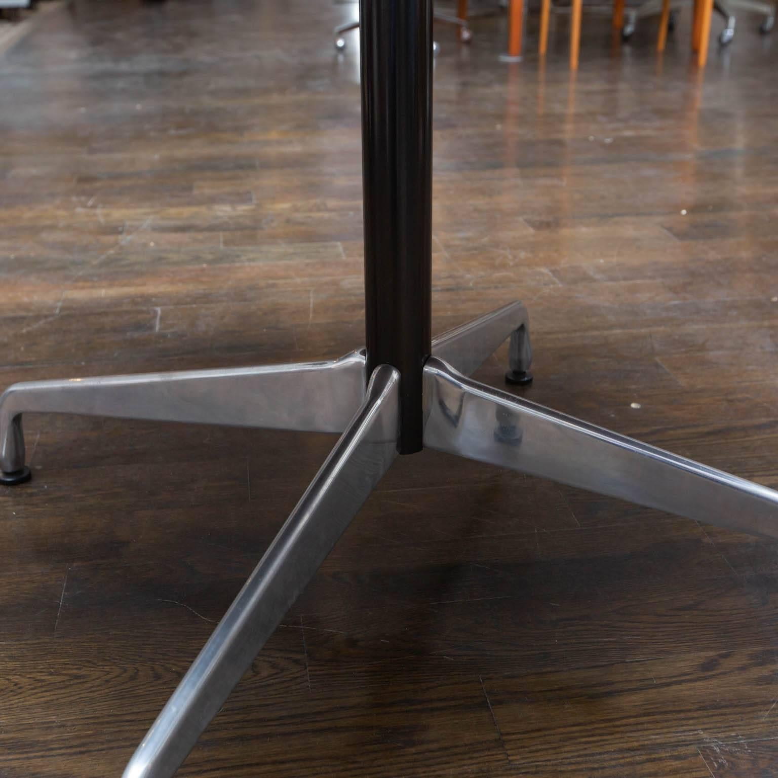 Eames design for Herman Miller Features aluminum star base and wood laminate top. Measures: 42