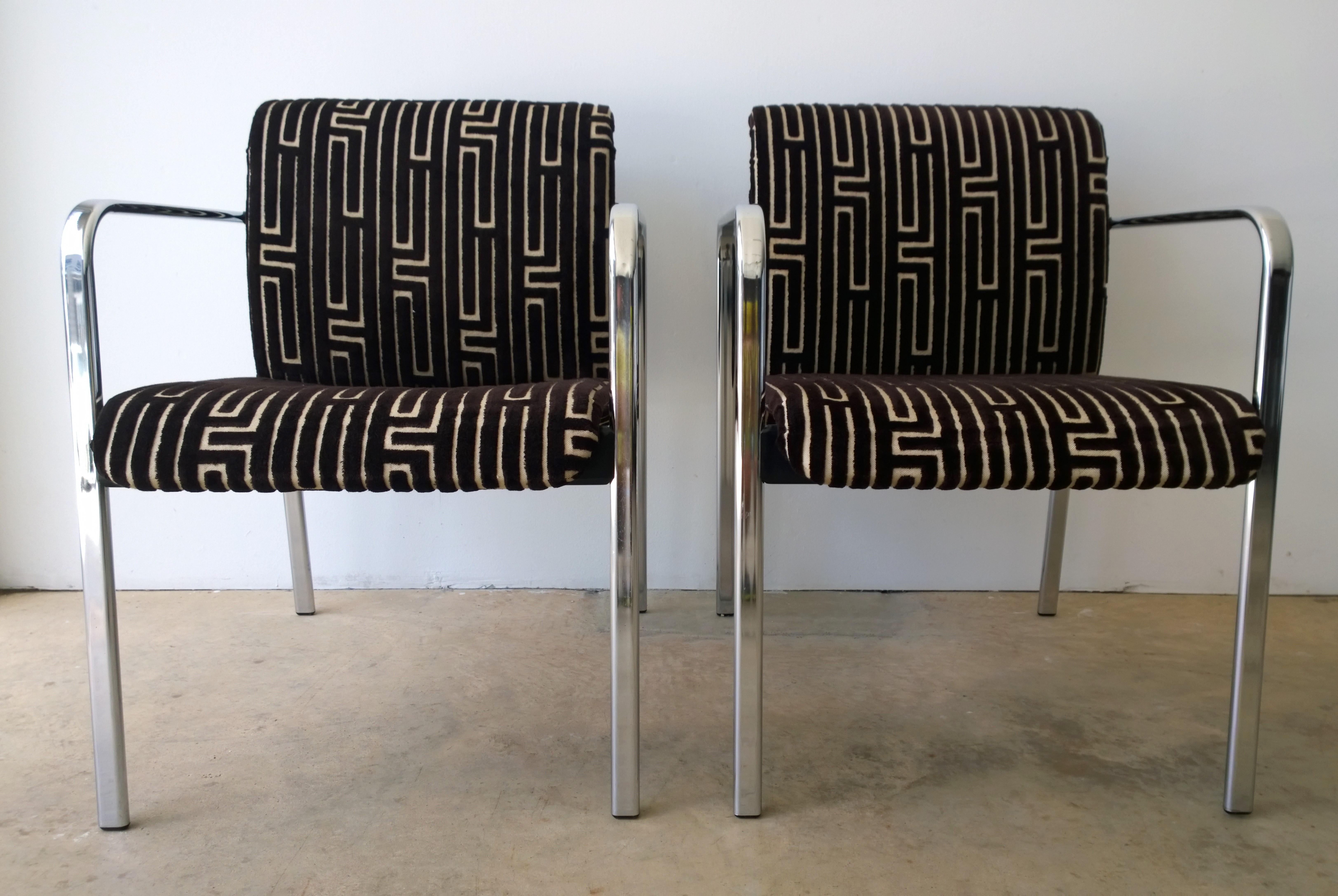 Offered is a pair of vintage Mid-Century Modern Peter Protzman for Herman Miller chrome-plated armchairs with black rubber accents that have been newly upholstered in a burnt-out chocolate brown and tan velvet geometric-Greek key style fabric.