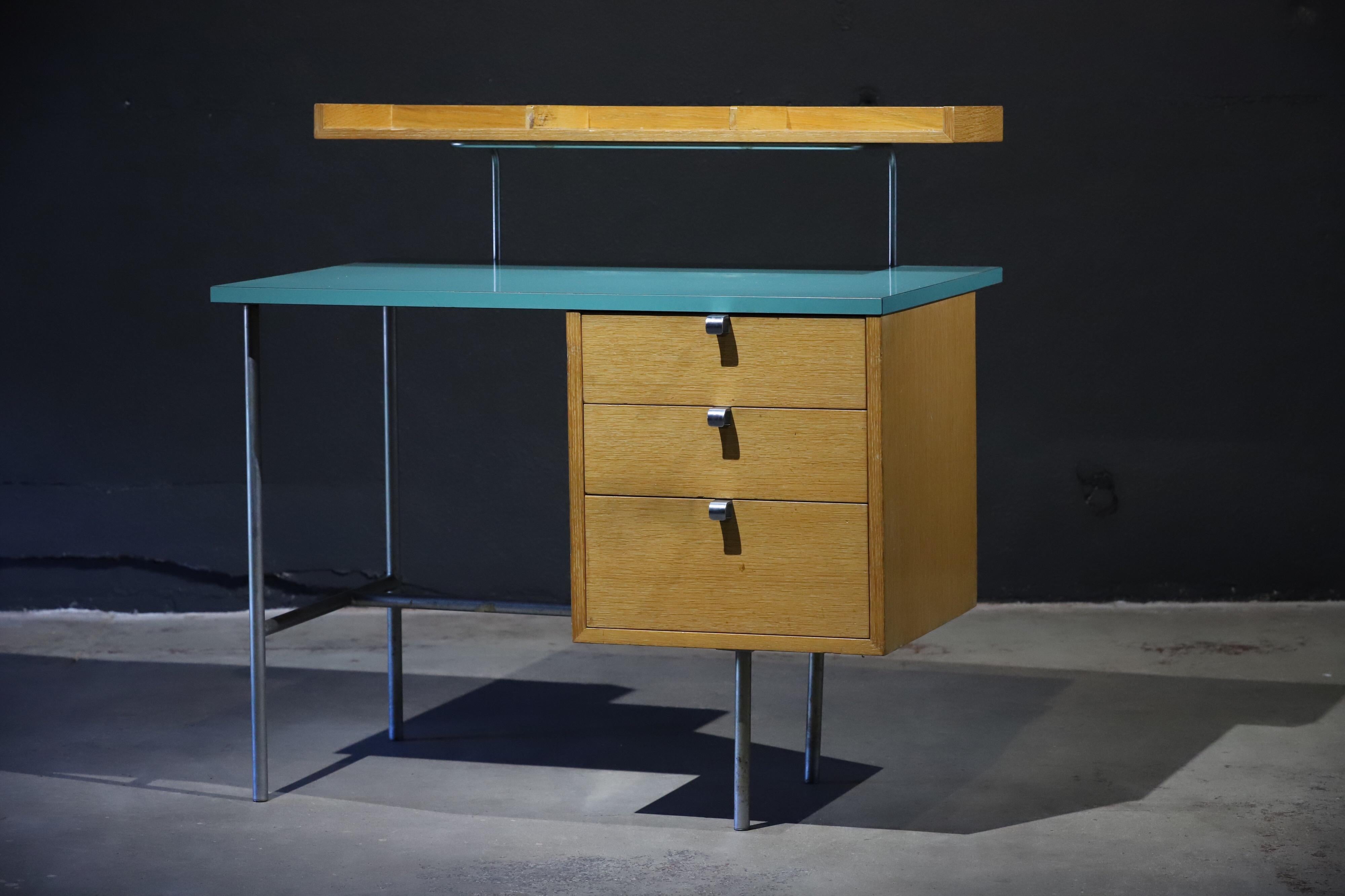Absolutely a lightweight knockout. This small desk by George Nelson for Herman Miller features the rarely seen TU-1 over-desk tray and wonderful turquoise Formica style top. Photographed with an Eames dowel leg wire chair for scale.