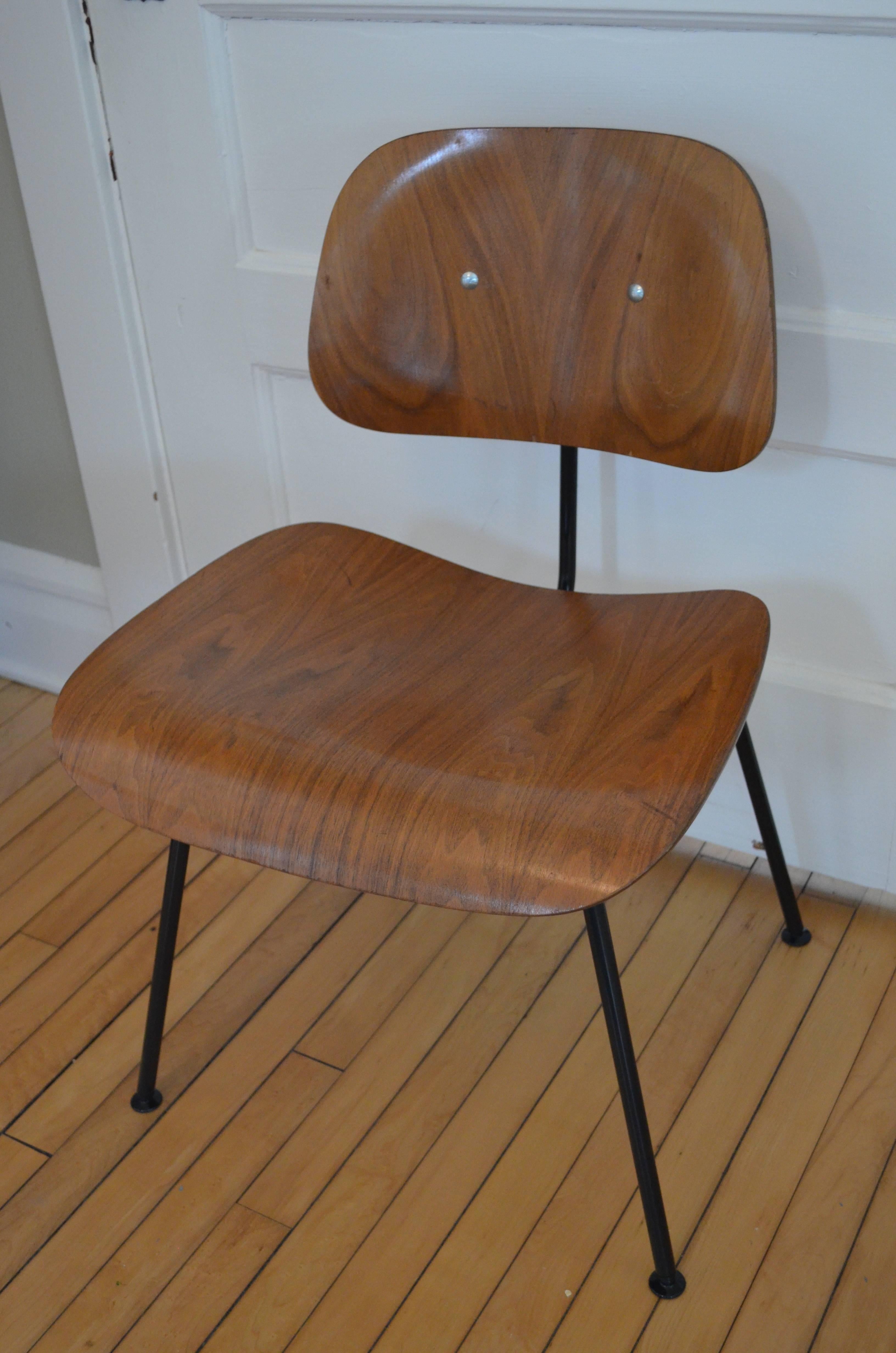 Mid-Century Modern Herman Miller walnut dining room chair, circa 1950s with new black steel frame from Herman Miller. The original icon 