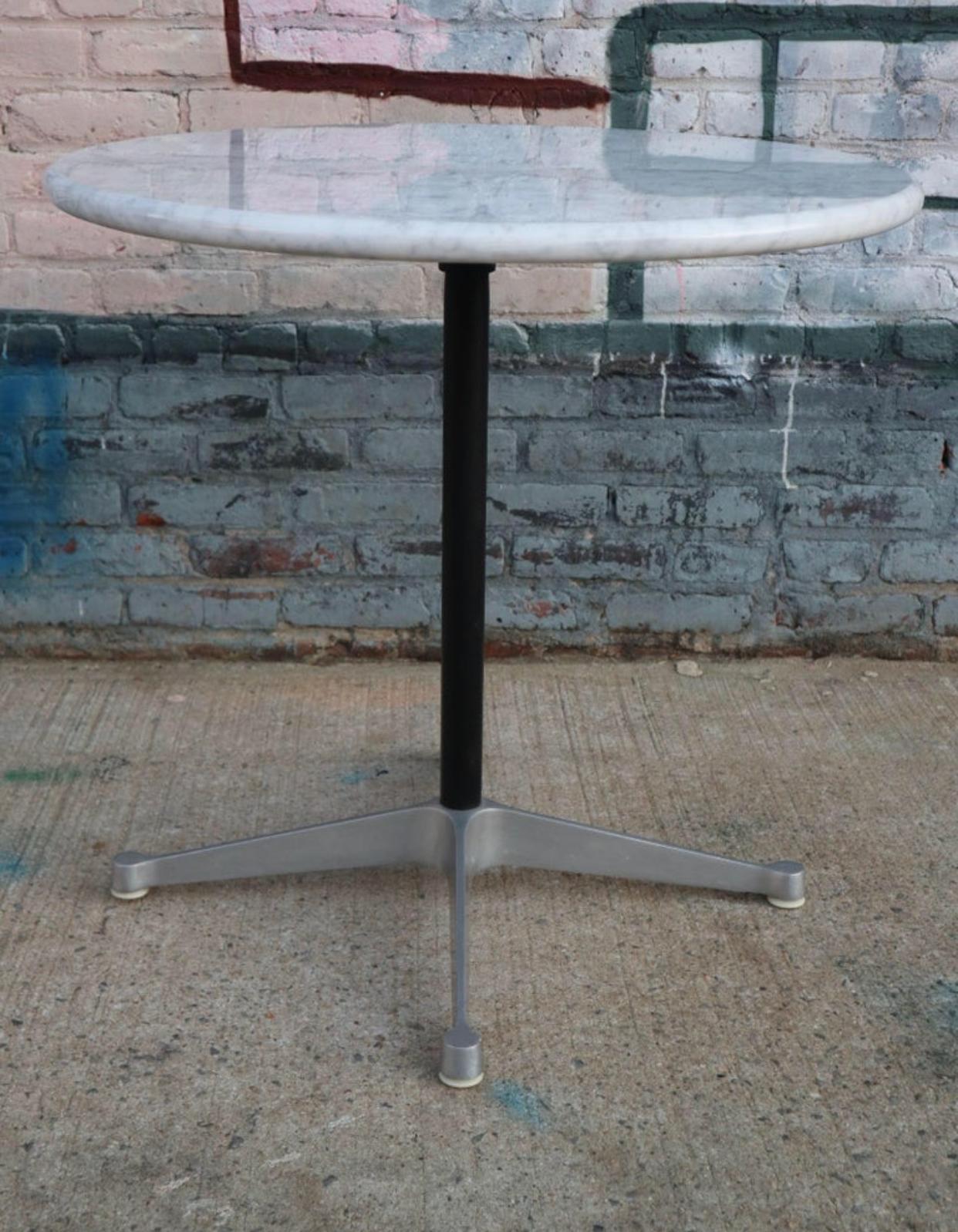 Gorgeous cafe sized dining table. Herman Miller Eames aluminum group base with new custom cut Carrara marble 30 inch top. Full bullnose rounded edge. Heavy and sturdy. Perfect for smaller spaces like a breakfast nook, porch, or apartment. This is a