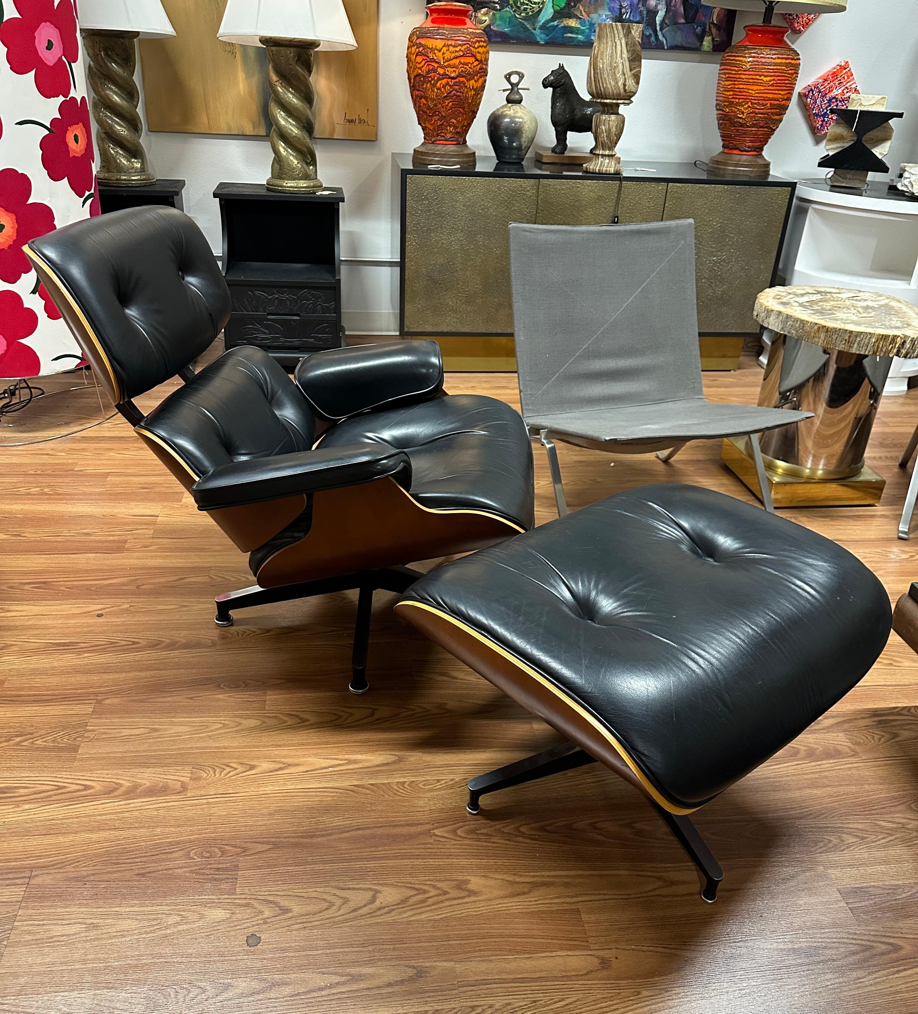 A lovely cherry wood veneered Eames lounge chair and ottoman by Herman Miller out of an architect’s home in Palm Springs. The tags date the production of this chair to 2005. Black leather.  It’s unusual to see these chairs in the cherry wood