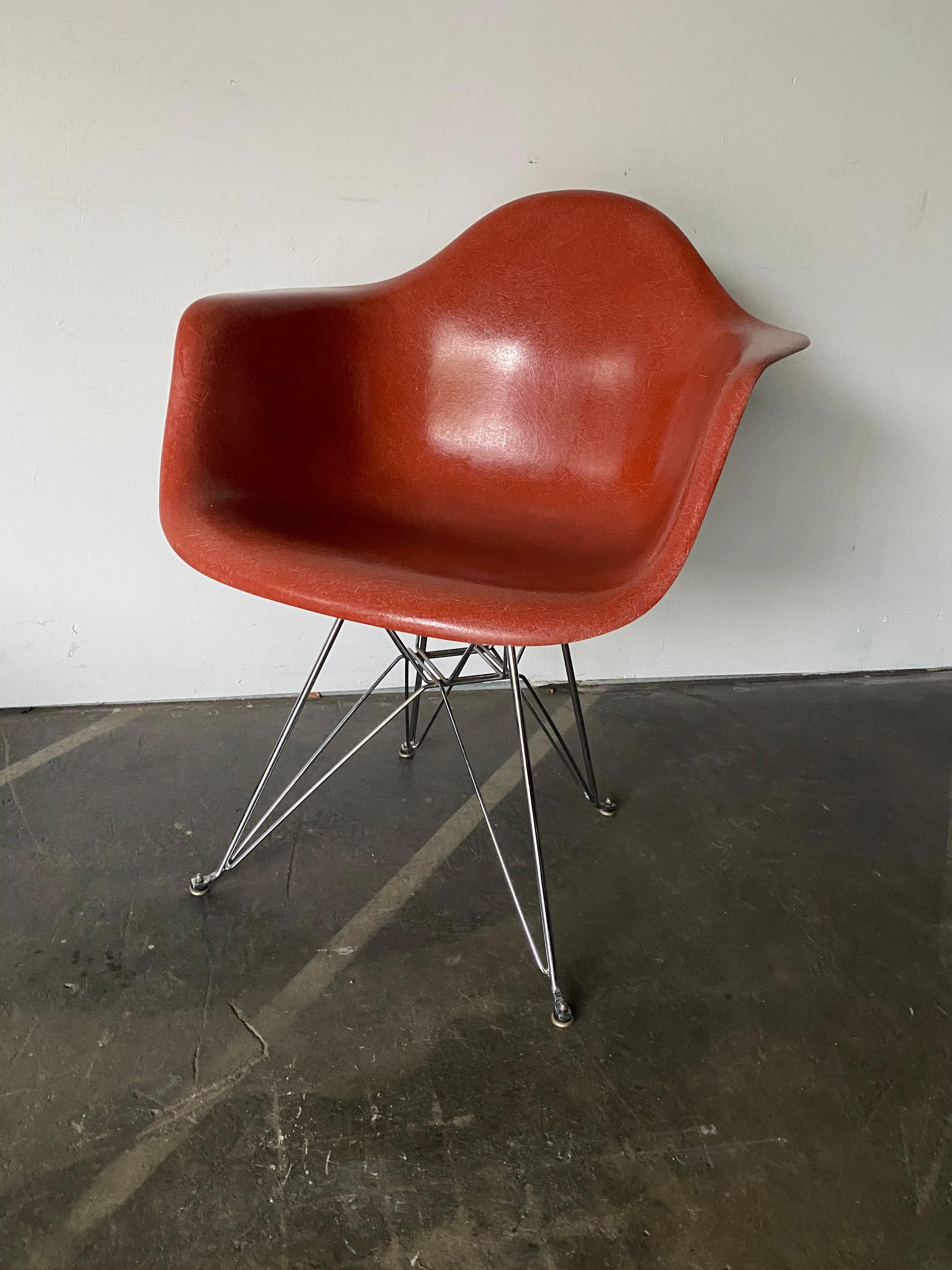 Gorgeous and rare hue of terracotta on this vintage fiberglass Herman Miller Eames armchair. Model DAR with Eiffel base. No cracks. All shock mounts intact. Stamped Herman Miller under chair and guaranteed authentic.