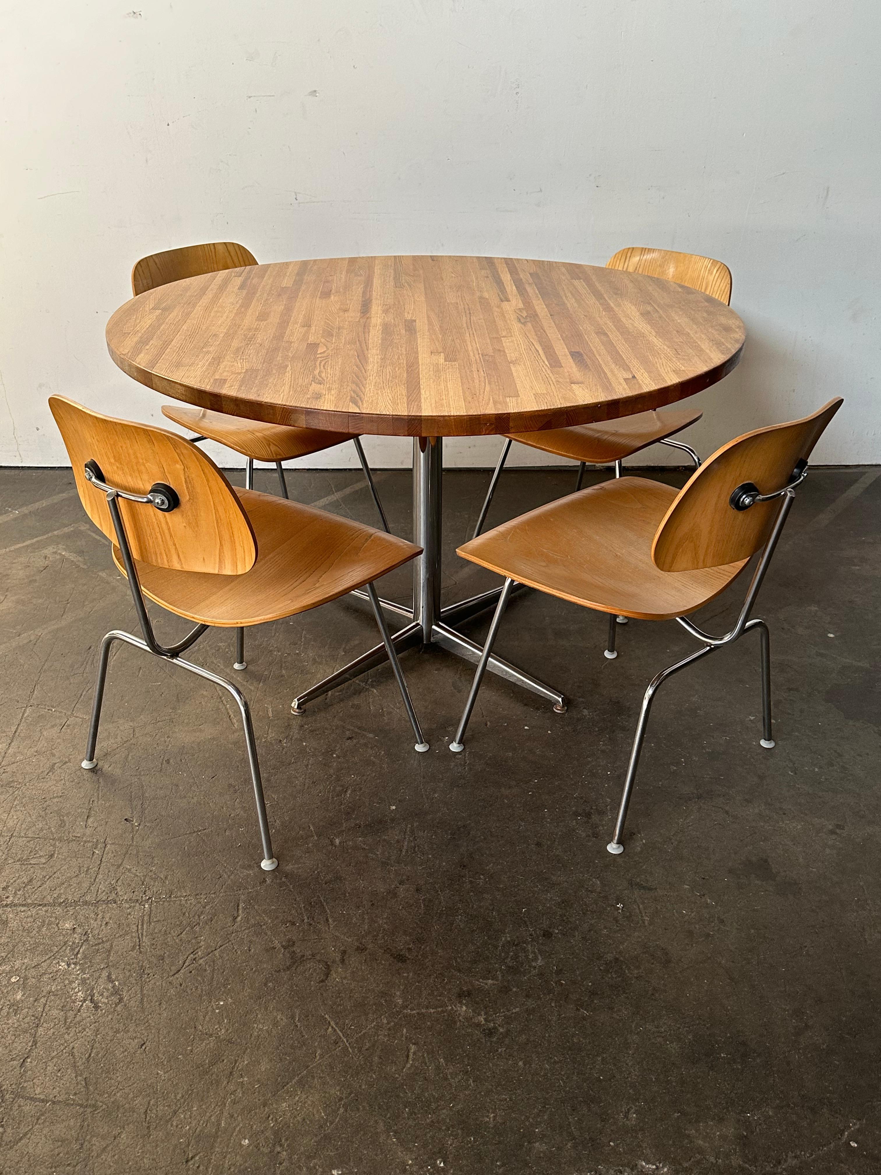 Classic Herman Miller Eames molded wooden DCM dining chairs in Ash paired with Ash butcher block round dining table. Both feature chrome steel frames and base. 48 inch table comfortably accommodates 4 chairs with room to spare.  A perfect pairing of