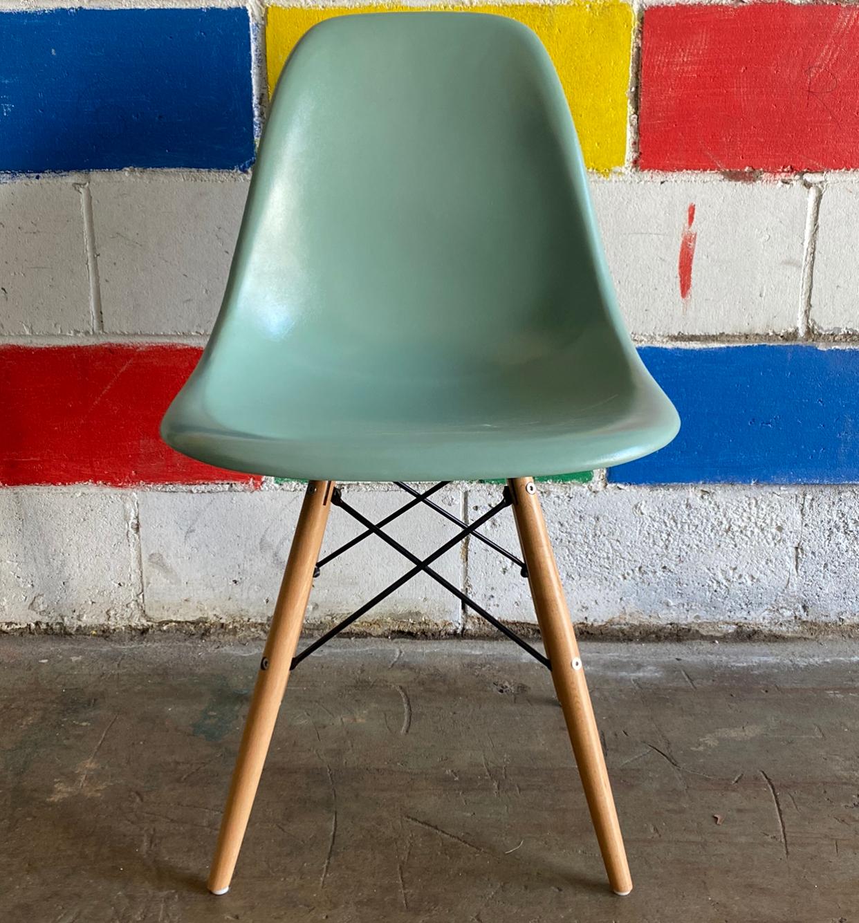 Set of 4 Herman Miller Eames dining chairs recoated in seafoam green. Authentic signed shells sit atop new wooden dowel bases. No cracks to the chairs.