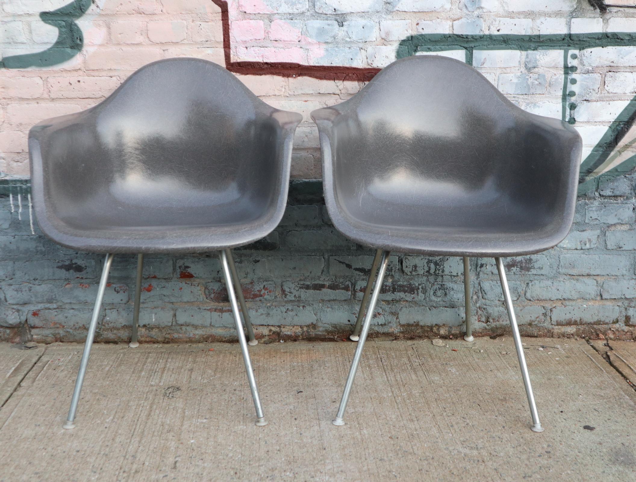 Matching pair of Herman Miller Eames fiberglass armchairs from the 1960s. Signed and embossed Herman Miller. With authentic vintage Herman Miller bases. All floor glides intact with self leveling feature. No cracks or significant wear. Gorgeous pair