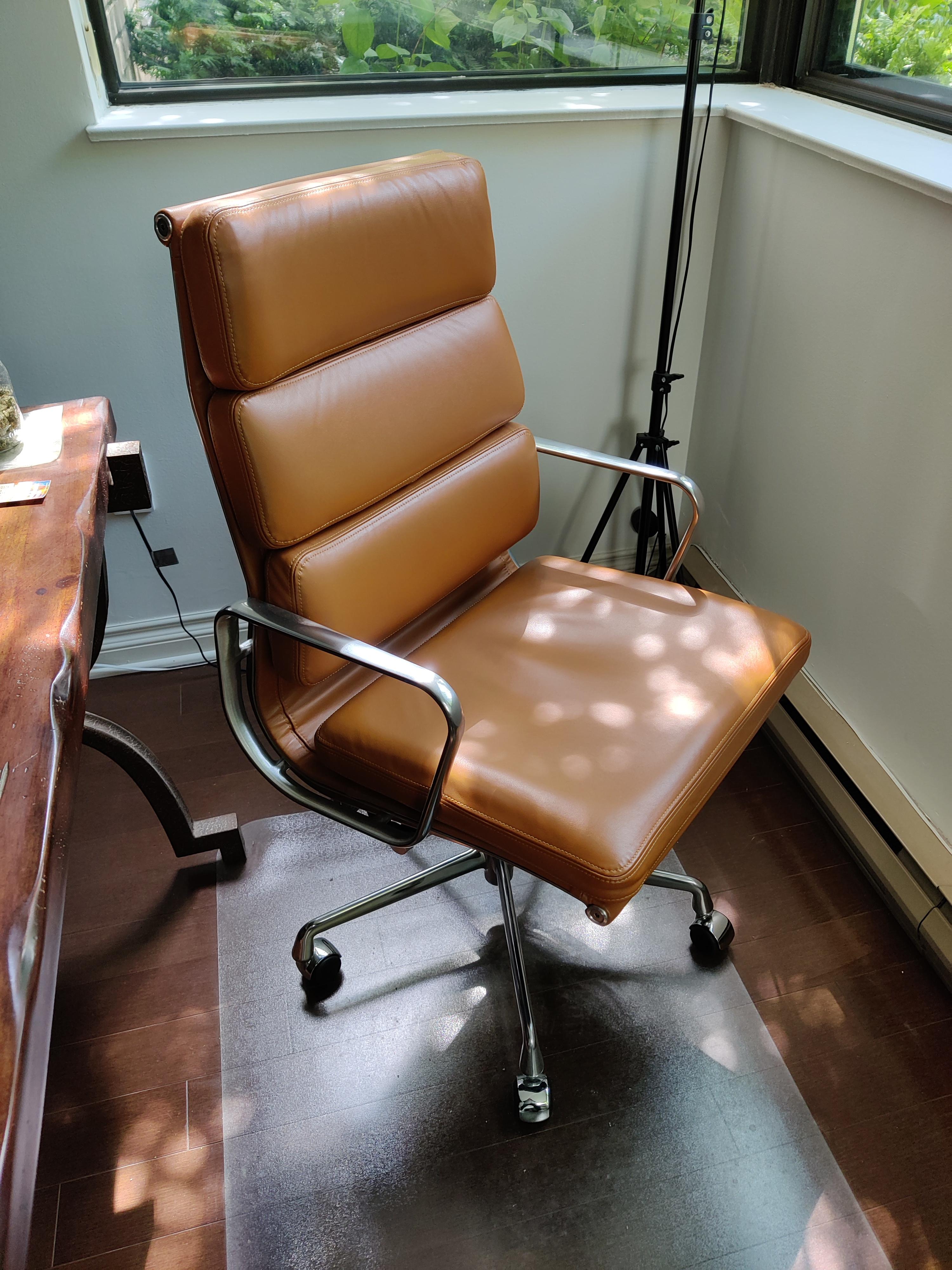 Pre-owned, nearly new, executive height Herman Miller soft pad Eames chair in tan leather. A seating solution that exudes both luxury and comfort. Designed by Charles and Ray Eames in 1969, this iconic chair is a true testament to the duo's