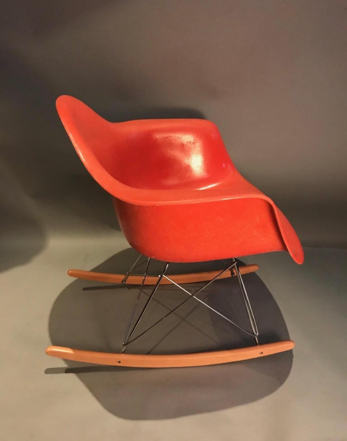 Lovely vintage Herman Miller Eames rocking chair. Model RRAR, circa 1960s shell with newer rocker base. Signed with original Herman Miller tags. Beautiful vibrant color even throughout.