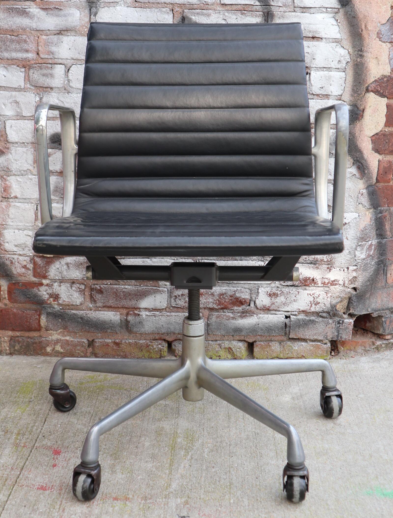 Gorgeous original Herman Miller Eames leather management. Polished aluminum frame with extremely comfortable leather sling seat. Arms with normal wear. Wheels work fine. Signed and stamped.