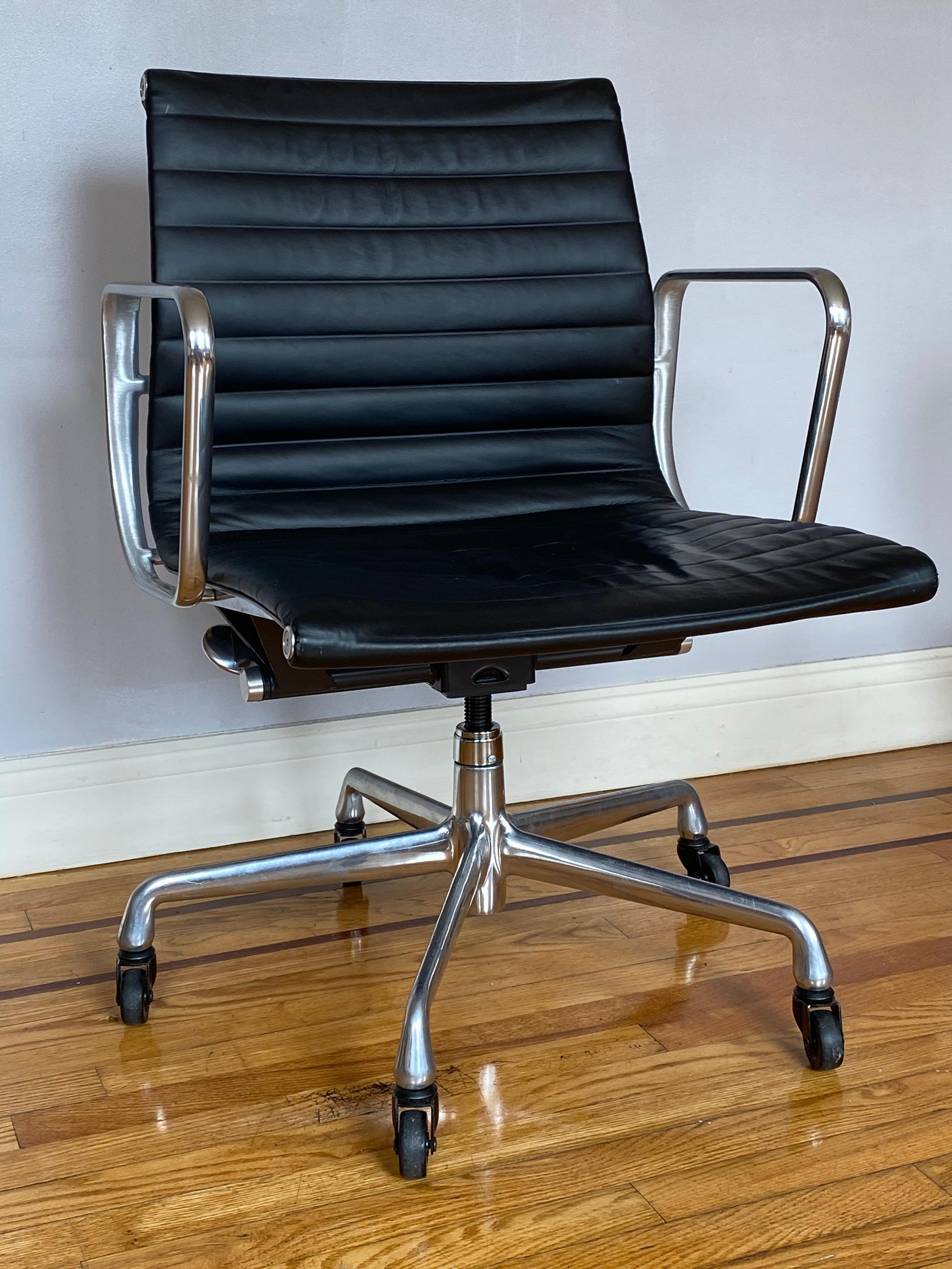 Gorgeous original Herman Miller Eames leather management. Polished aluminum frame with extremely comfortable leather sling seat. Arms with wear from use. Wheels work fine. Signed and stamped.