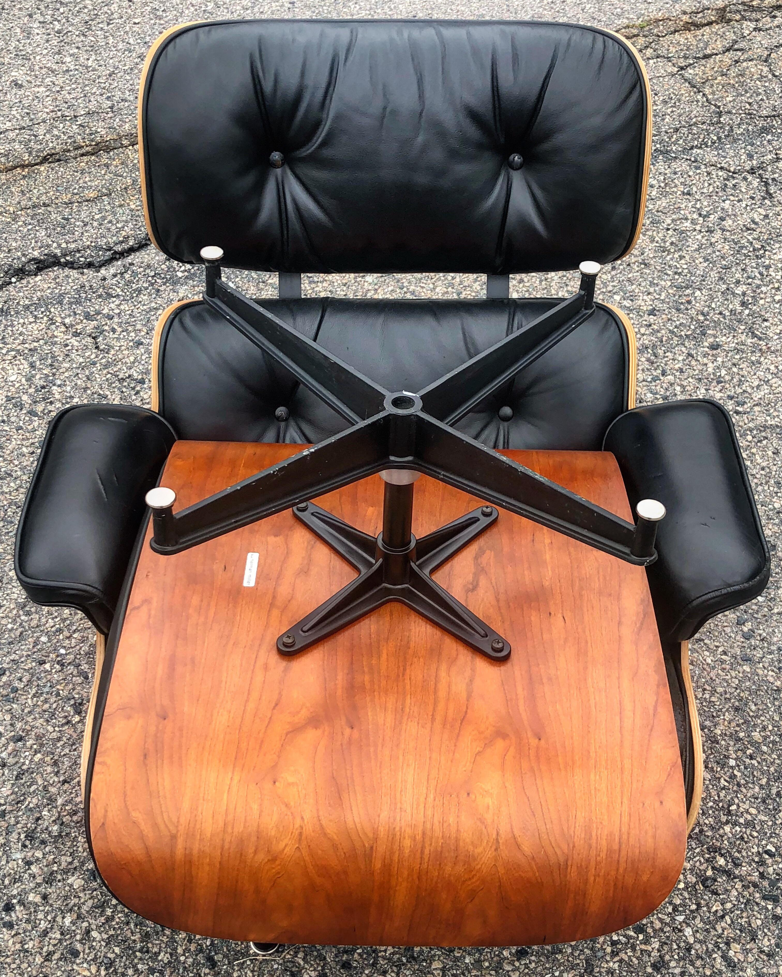 Herman Miller Eames lounge chair and ottoman. Gorgeous oiled cherry shells and original black leather. Wood near perfect. A gorgeous edition of the design classic. Signed Herman Miller.