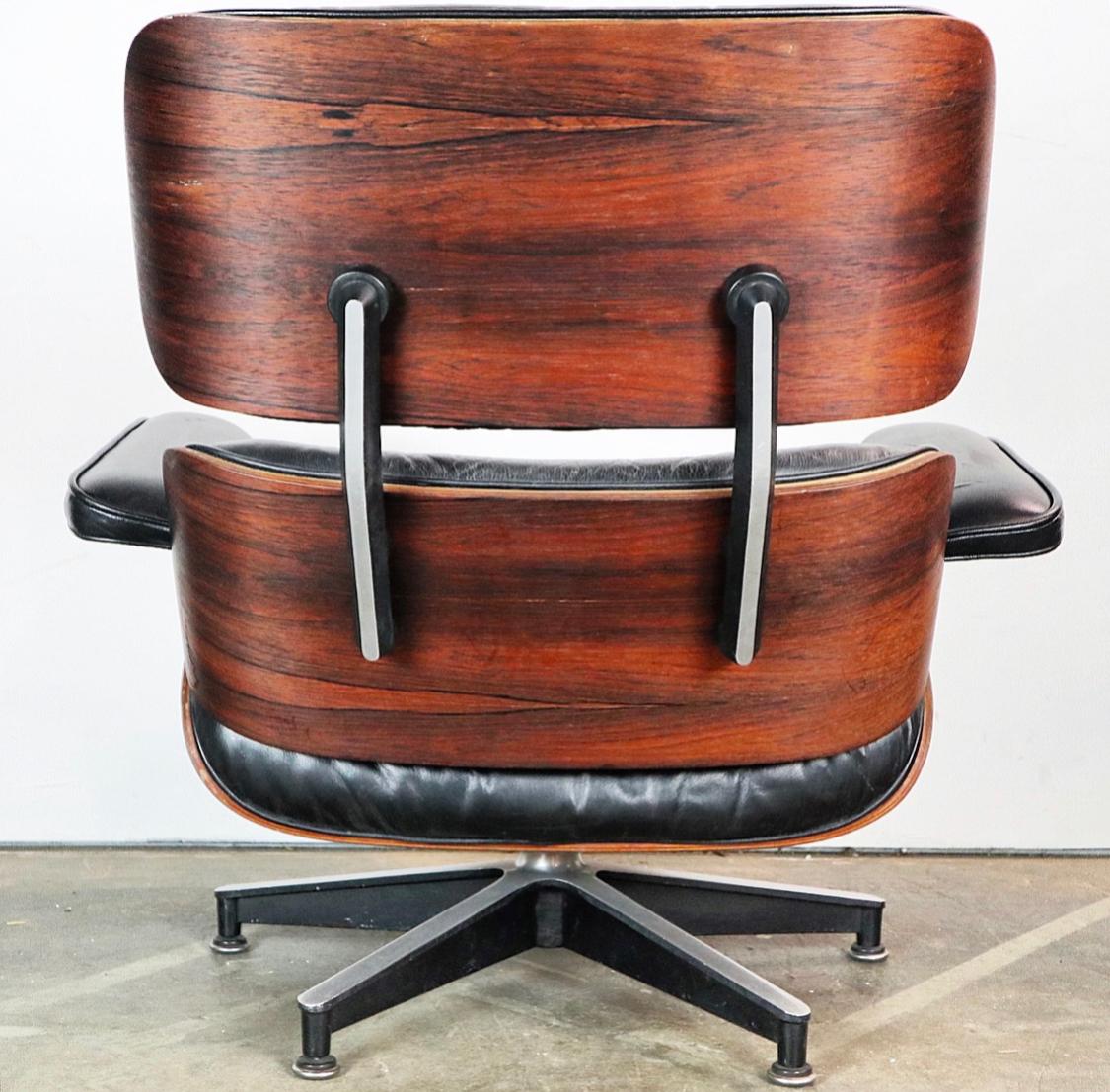 Stunning rosewood shells adorn this Classic Herman Miller Eames lounge chair and ottoman. Comfortable foam cushions allow for both working and napping. Cushions repainted even black. Signed and guaranteed authentic. Original chair and ottoman set.
