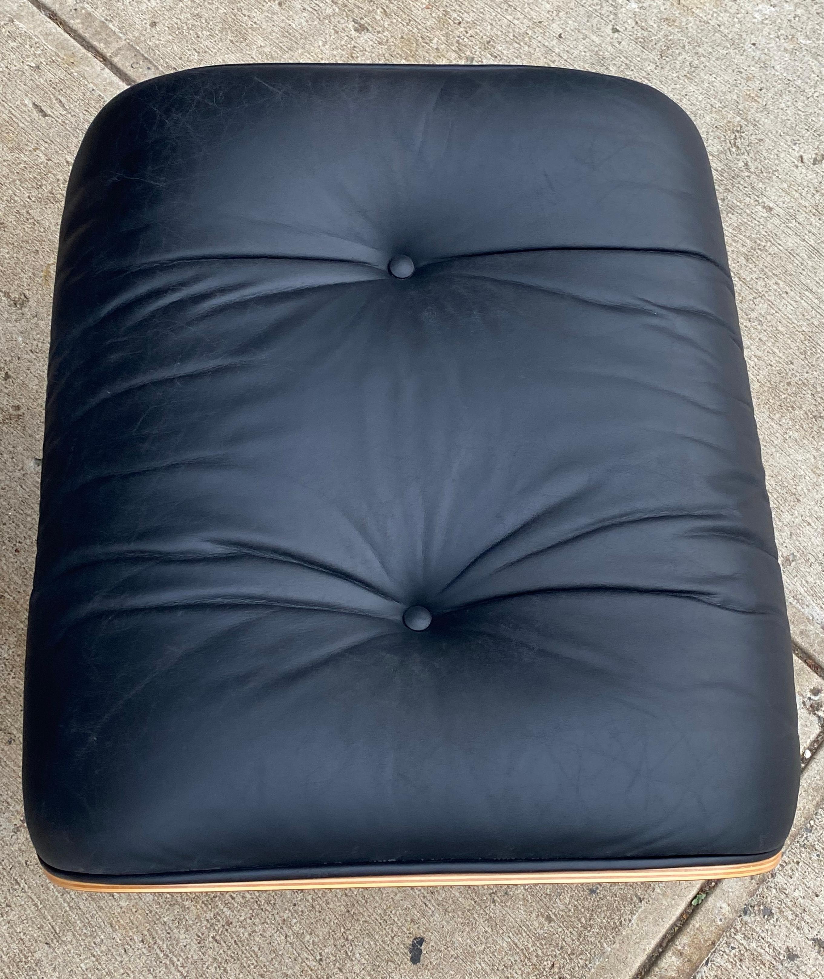 Vintage Herman Miller Eames lounge chair and ottoman. Black leather cushions are a beautiful contrast to the warm tones of the walnut exterior. Wood has been oiled and maintains warm glow. Signed on both chair and ottoman and guaranteed authentic.