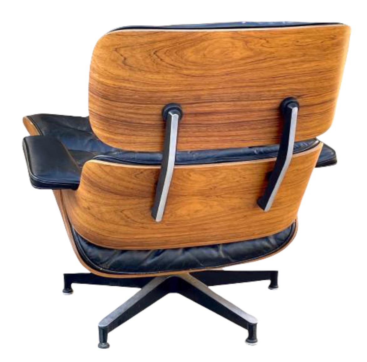 Classic example of the iconic Eames 670/671 lounge and ottoman for Herman Miller. Executed in Brazilian rosewood with black leather. Stunning attractive rosewood grain pattern and color. Seat shock mounts replaced by Herman Miller (at $600 value).