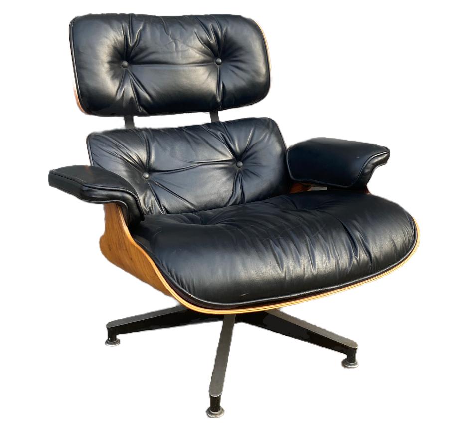 Classic example of the iconic Eames 670/671 lounge and ottoman for Herman Miller. Executed in Brazilian rosewood with black leather. Stunning attractive rosewood grain pattern and color. Seat shock mounts replaced by Herman Miller (at $600 value).