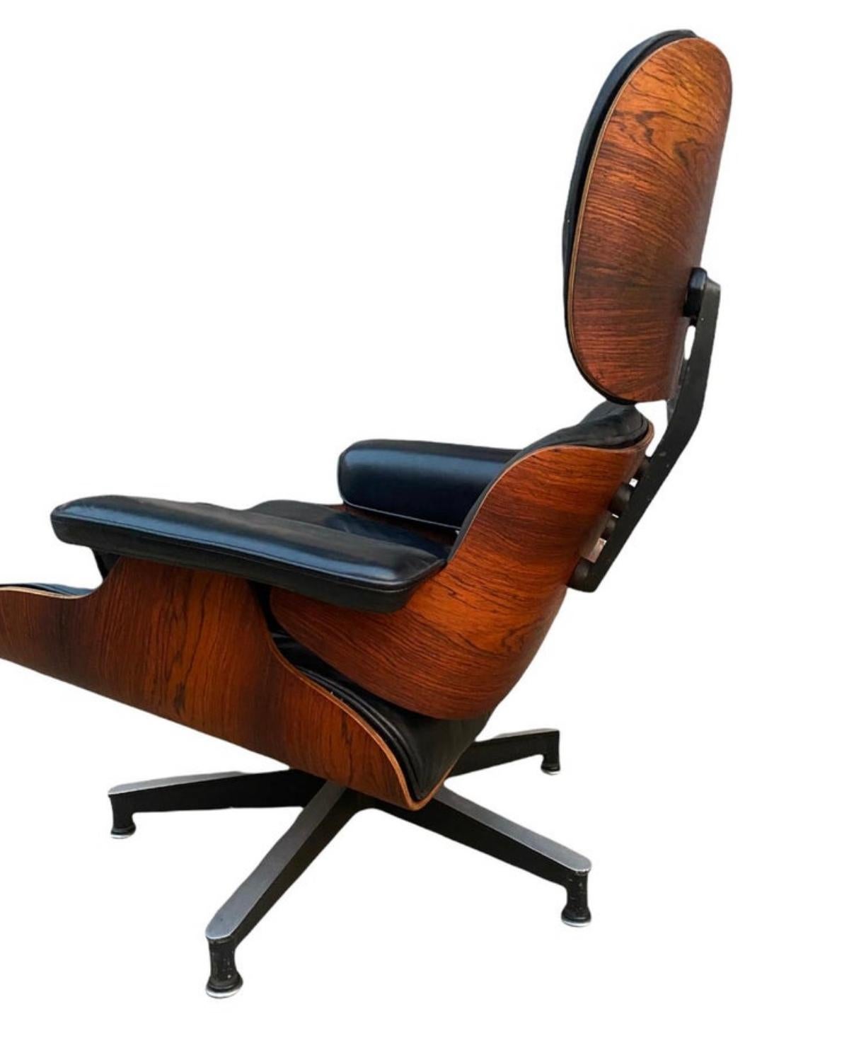 Classic Herman Miller Eames lounge chair and ottoman. Early edition circa 1960s. Executed in black leather and gorgeous toned and figured wood frame. Seat panel has been outfitted with new rubber shock mounts (all chairs eventually need this and it