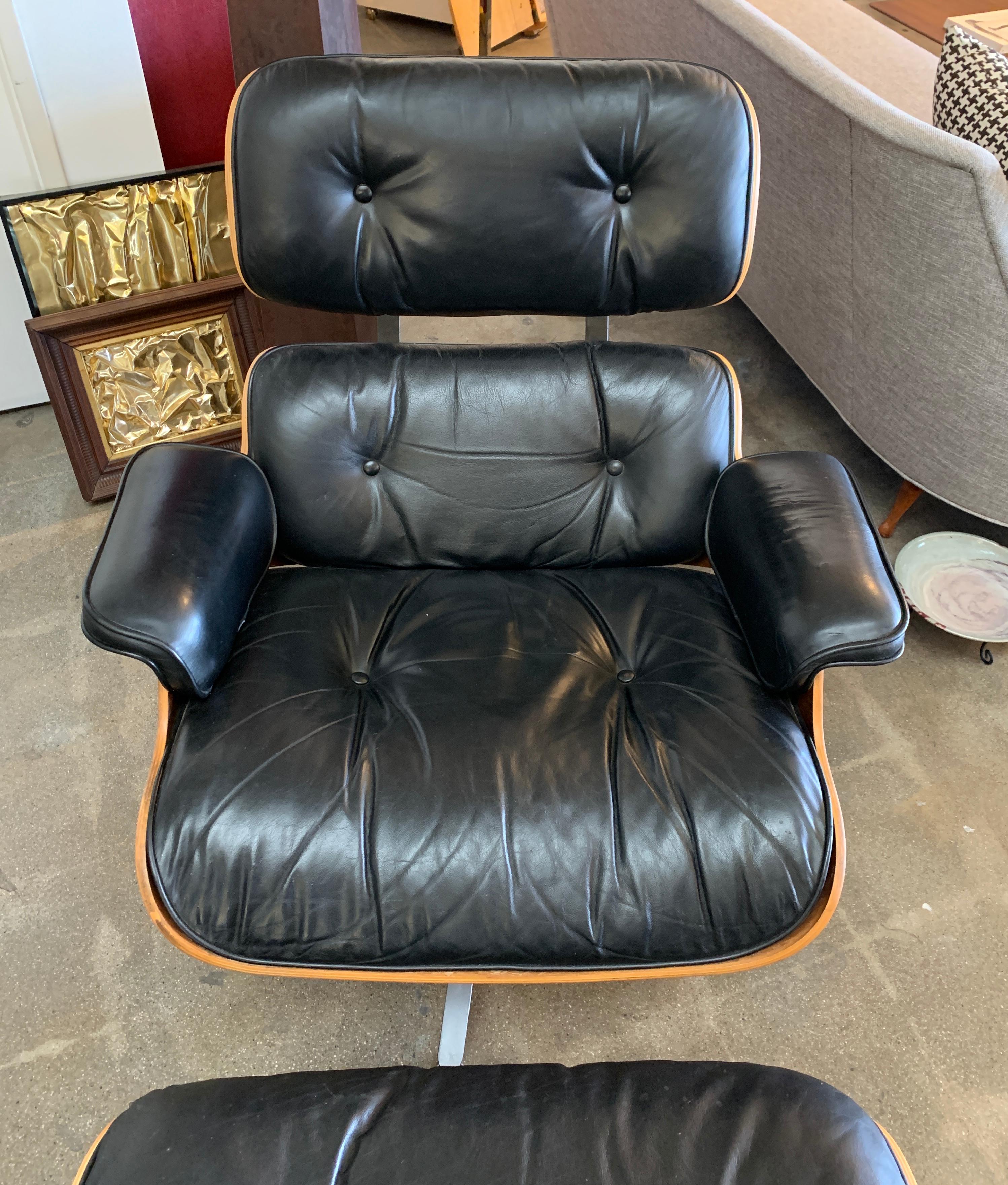 A 2006 labeled Eames lounge chair and ottoman by Herman Miller. Both pieces have Herman Miller tags and the chair has a Hume Modern Tag as well.This is the tall version at 33.5 inches tall at the back. It has presumably been restored at some point.