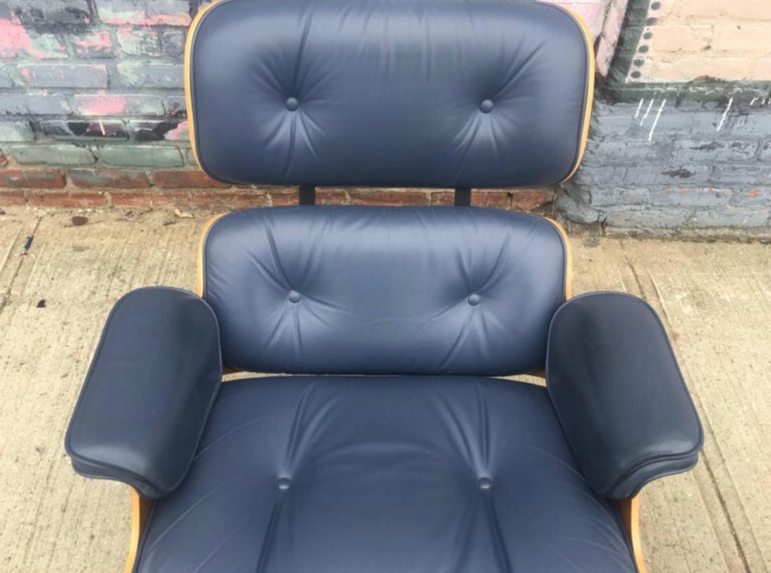 Gorgeous Herman Miller Eames lounge chair and ottoman. A wonderful example of the classic icon. Guaranteed authentic and signed with original labels. Handsomely figured walnut shells cradle uber comfortable cushions wrapped in supple custom blue