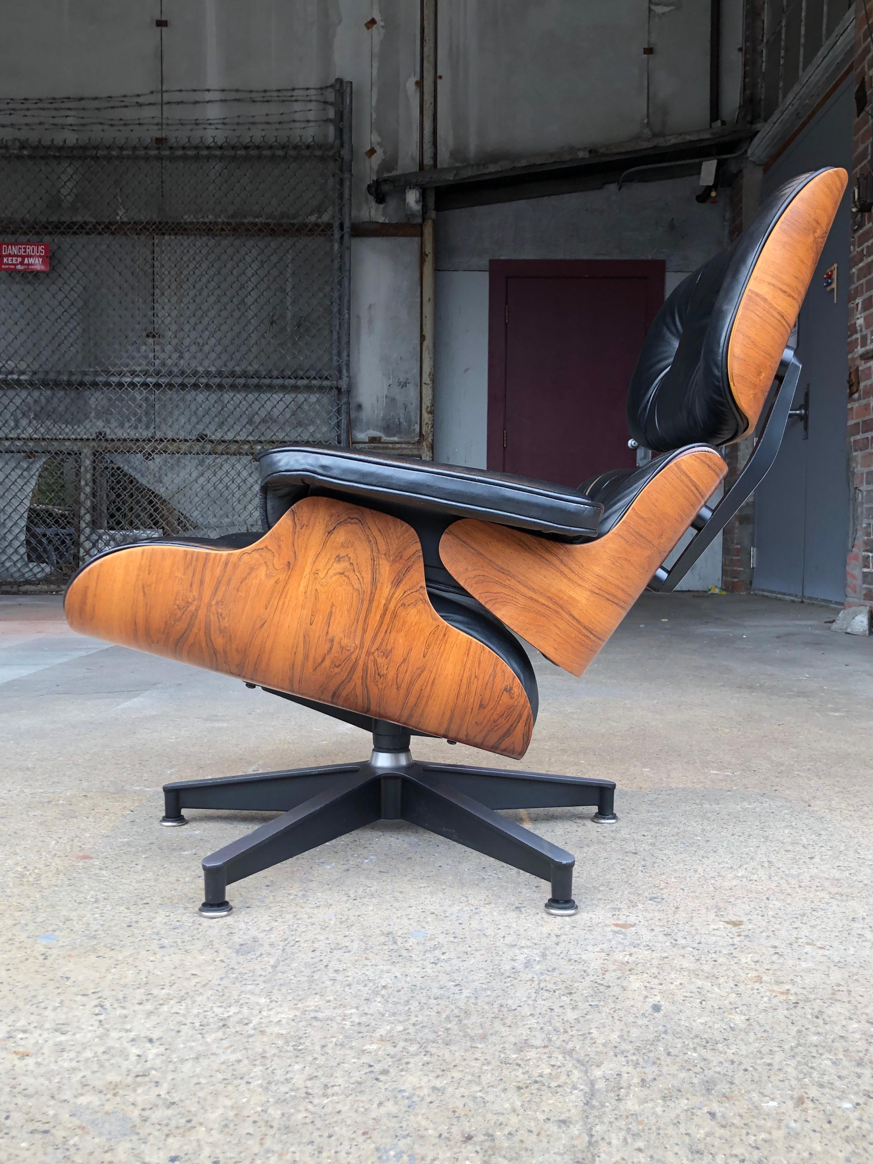 Gorgeous rosewood Eames chair with black leather. In very good vintage condition. Leather has been cleaned and conditioned. Rosewood exterior shells have been freshly oiled to bring out the luster and grain detail. Signed with Herman Miller makes