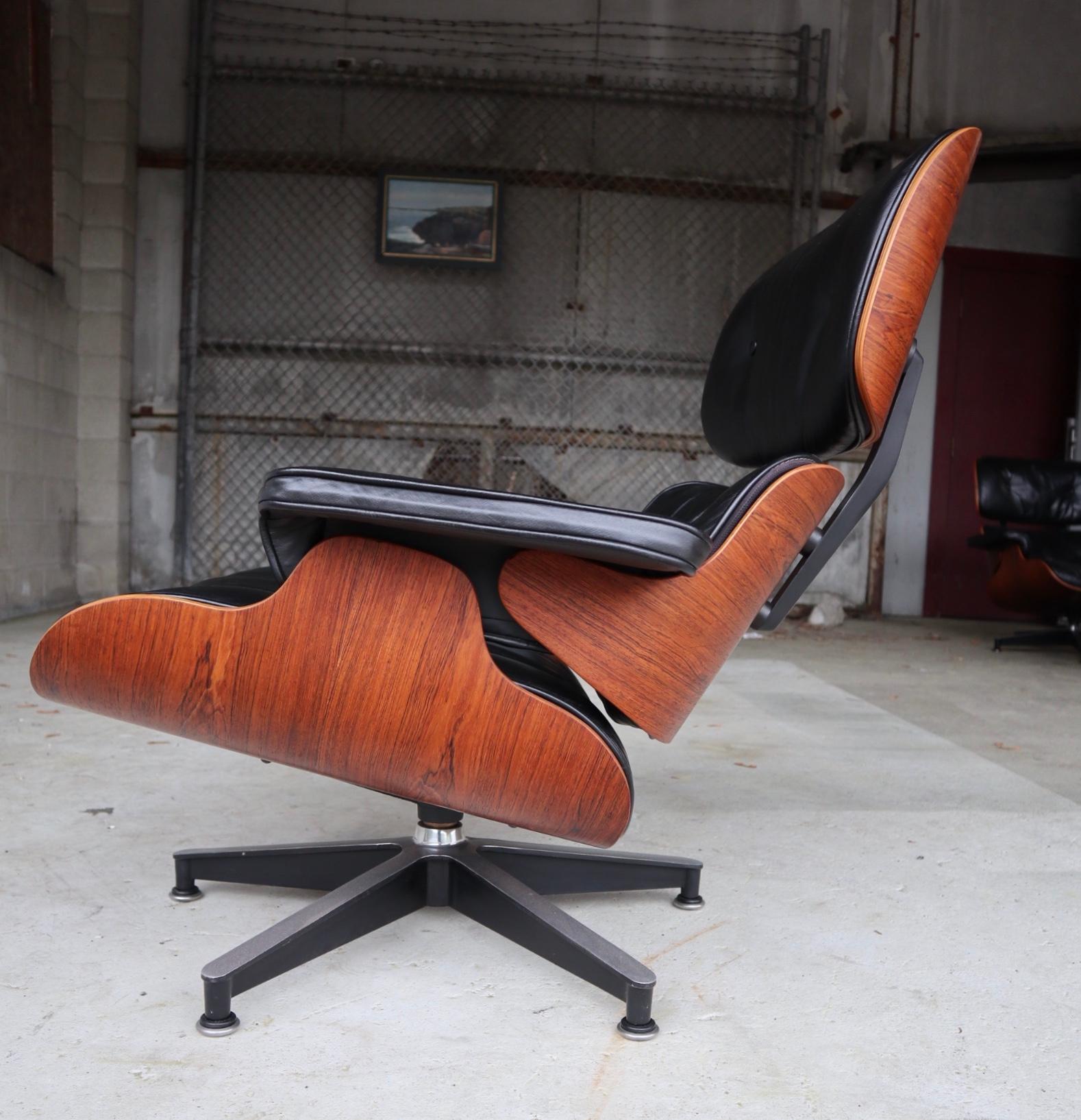 Gorgeous example of the iconic Herman Miller Eames lounge chair. Stunning vibrant color of the rosewood shells with original black leather cushions. Attractive even grains. Cushions extremely comfortable. The perfect lounge chair!
