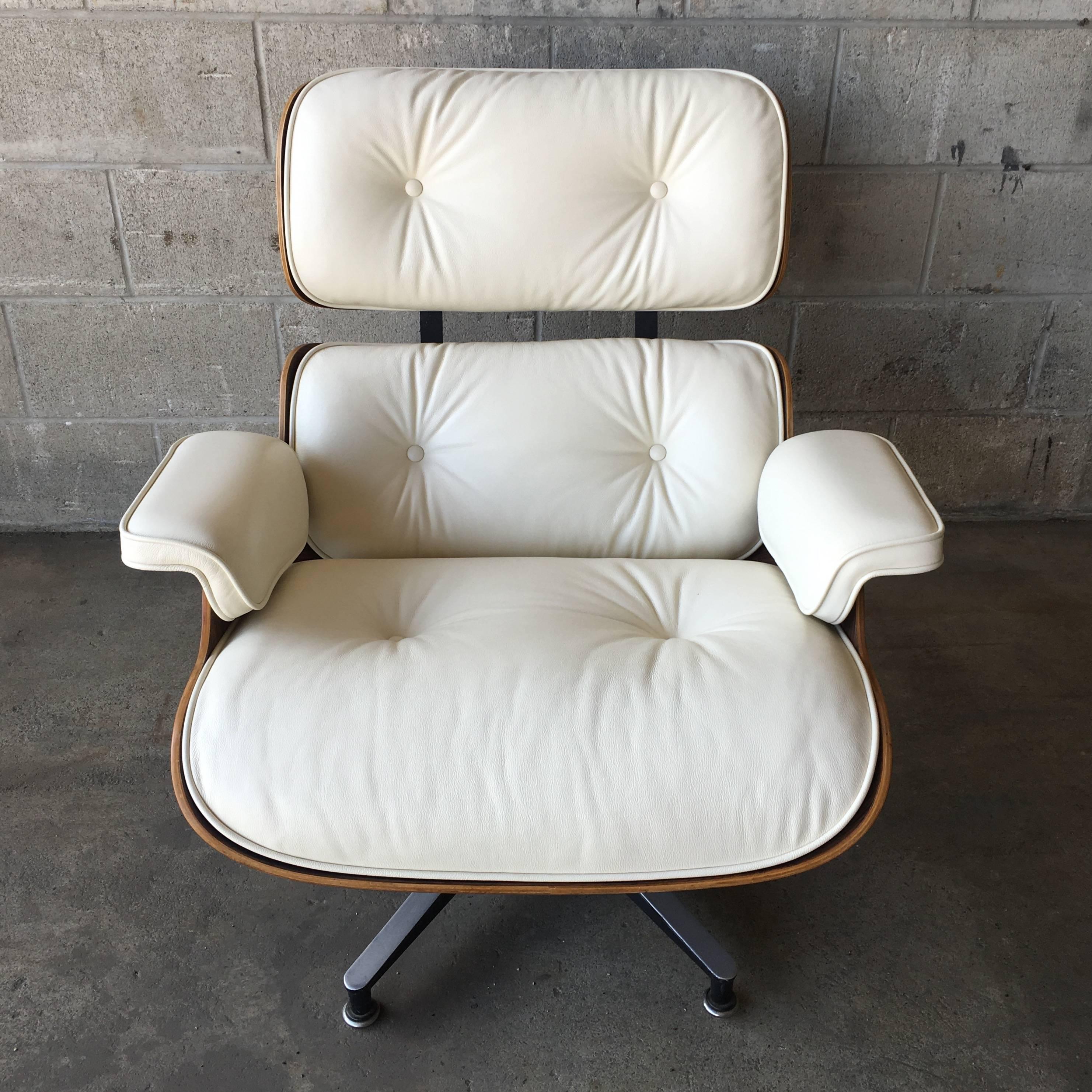 Rosewood Herman Miller Eames lounge chair and new ivory cushions in perfect condition. Impeccable wood color and grain detail. Cushions custom made to order with 3 week production time.