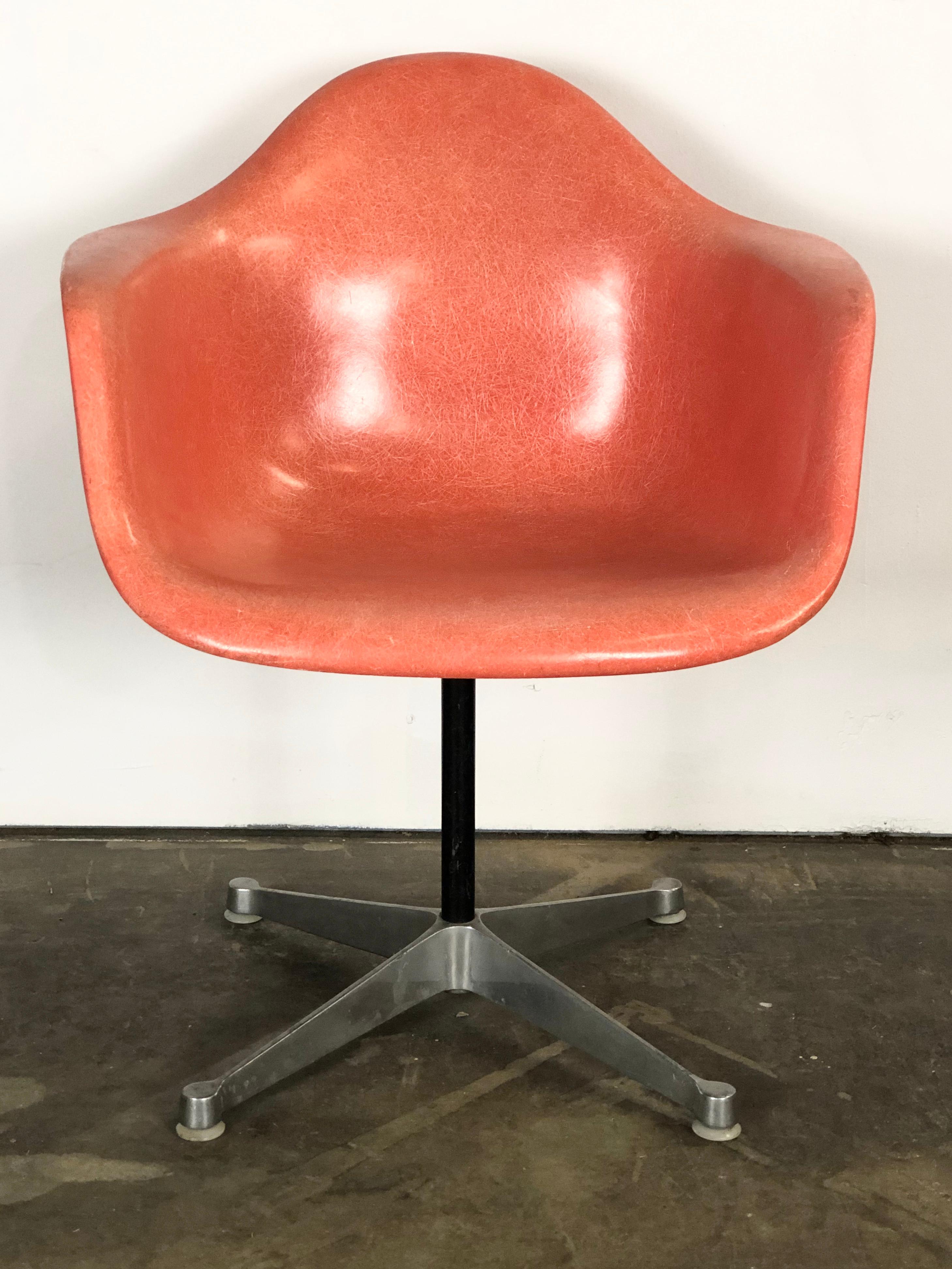 Gorgeous classic example of the Eames fiberglass armchair. A lovely red orange hue makes this among the most appealing and sought after colors of this design. No cracks or holes to the shell. Normal wear commensurate with age and use. Signed Herman