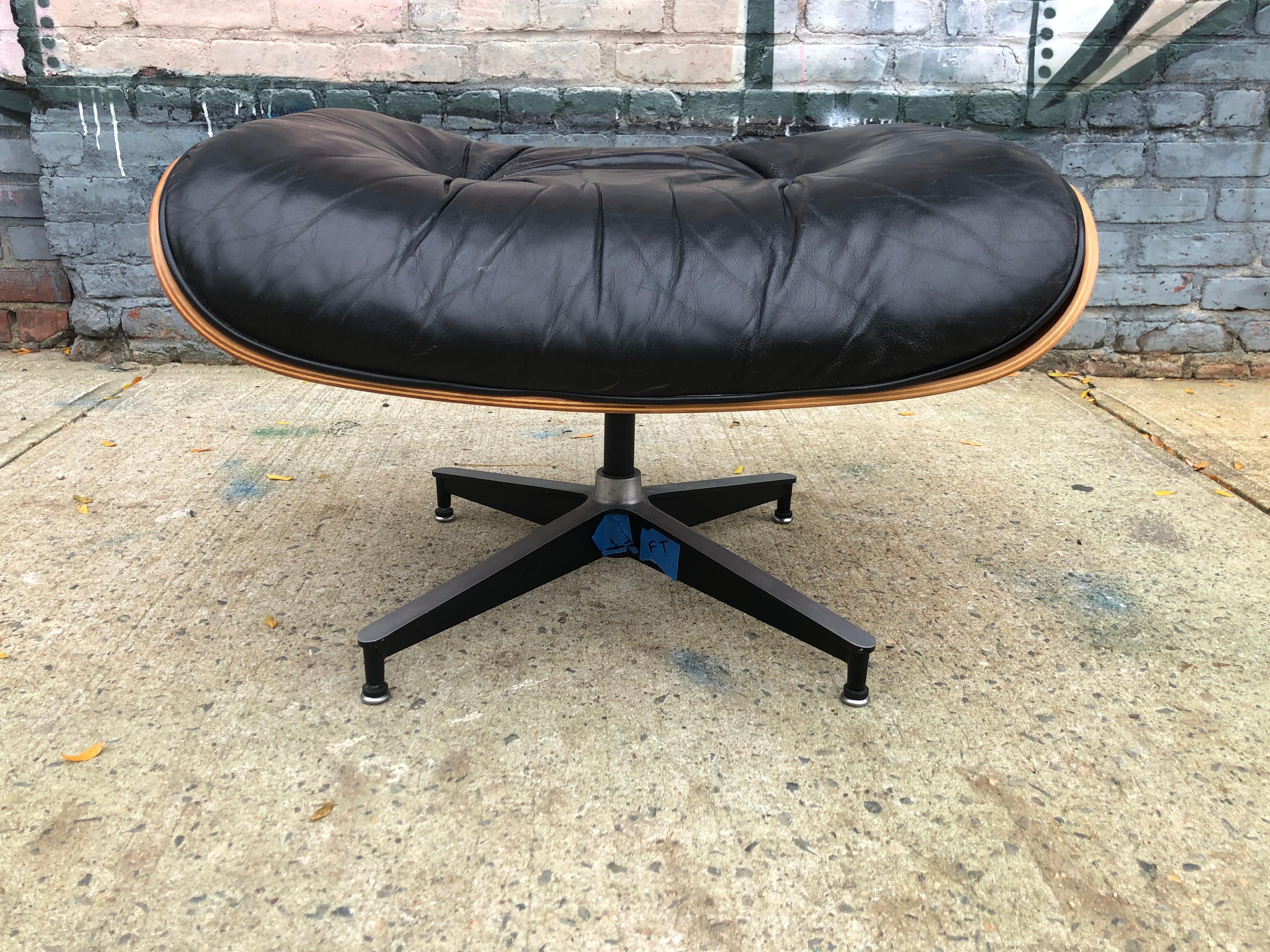 Herman Miller Eames ottoman or footstool in cherry and black leather. Signed Herman Miller. No tears or rips. Normal wear. Warm vibrant cherry color and grains. Add this to your chair to complete your set.