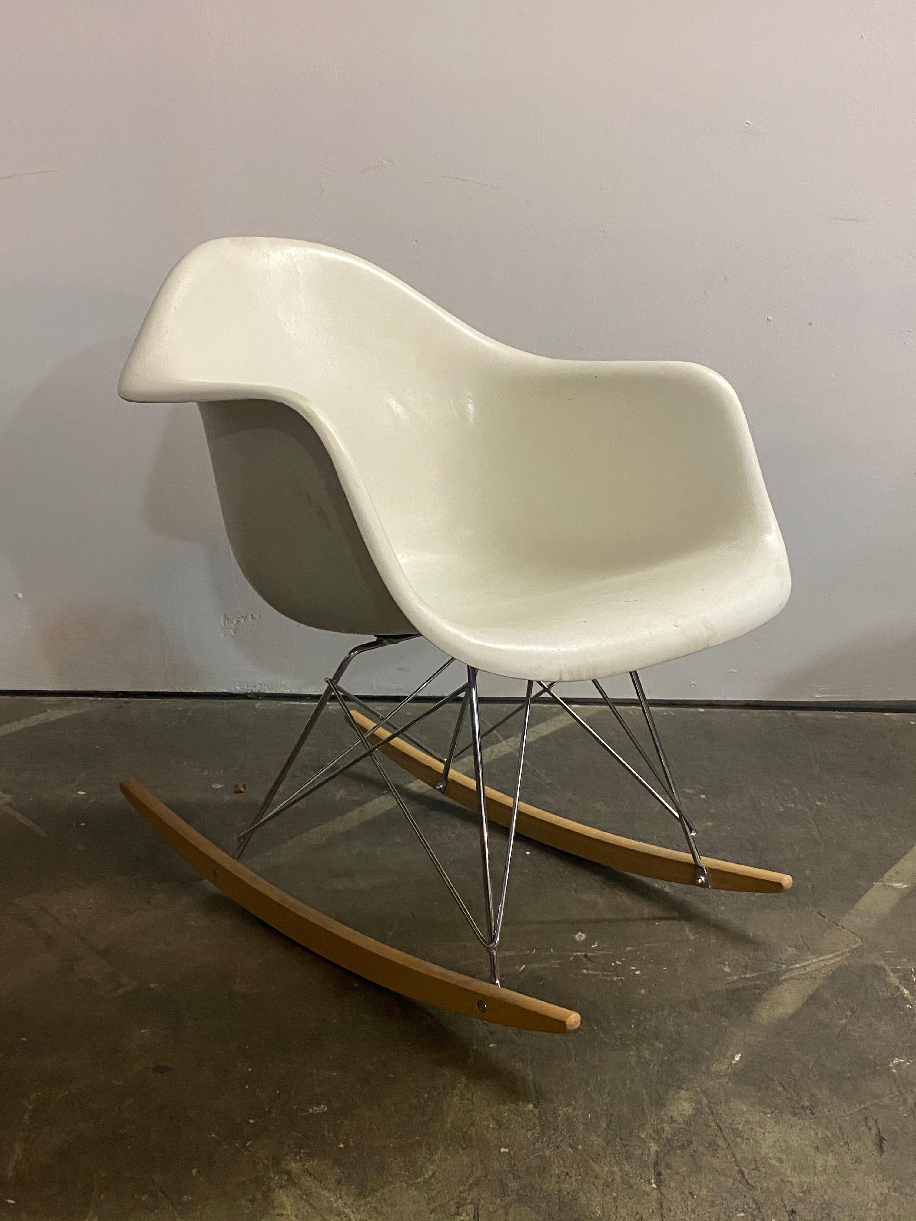 White Herman Miller Eames RAR rocking chair. Shell in good shape with no cracks. It was originally upholstered and the vinyl covering and foam were removed. Sturdy fiberglass shell structurally sound with elegant lines. The factory threaded inserts