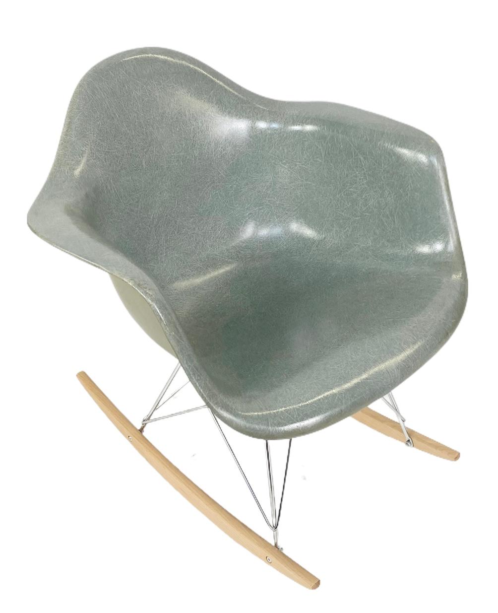 Very early shell, dating to circa 1960. Highly coveted and hard to find Seafoam green. On new rocker base, no cracks to the shell. Normal wear, retains Herman Miller label. Factory coated grey/green back. Original shock mounts intact. Signed and