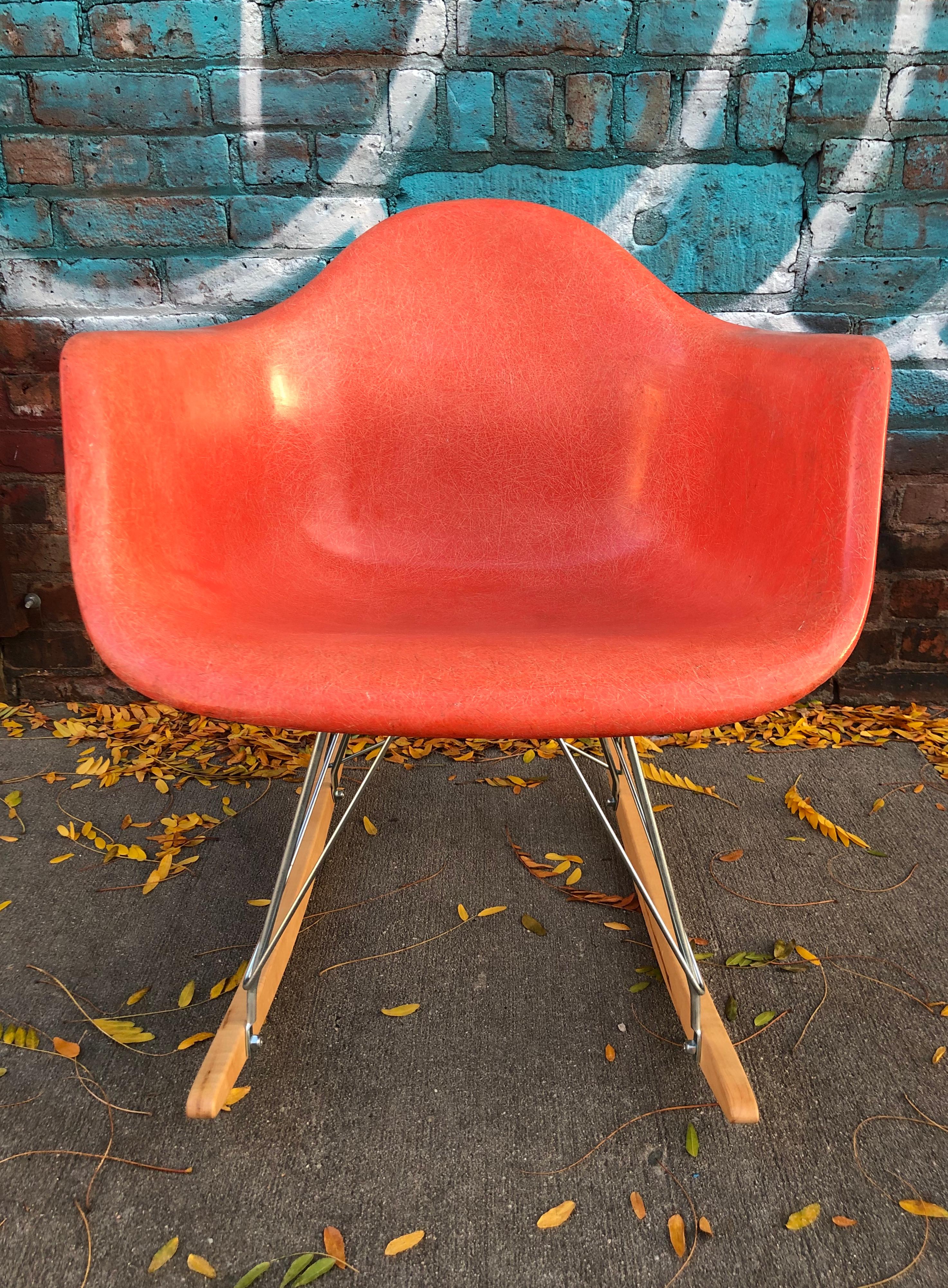 Gorgeous example of the Classic Herman Miller Eames RAR rocking chair. Vintage signed shell in good condition with no damage besides light normal wear. Sits atop newer Modern Conscience base with silver metal and maple runners. Includes vintage