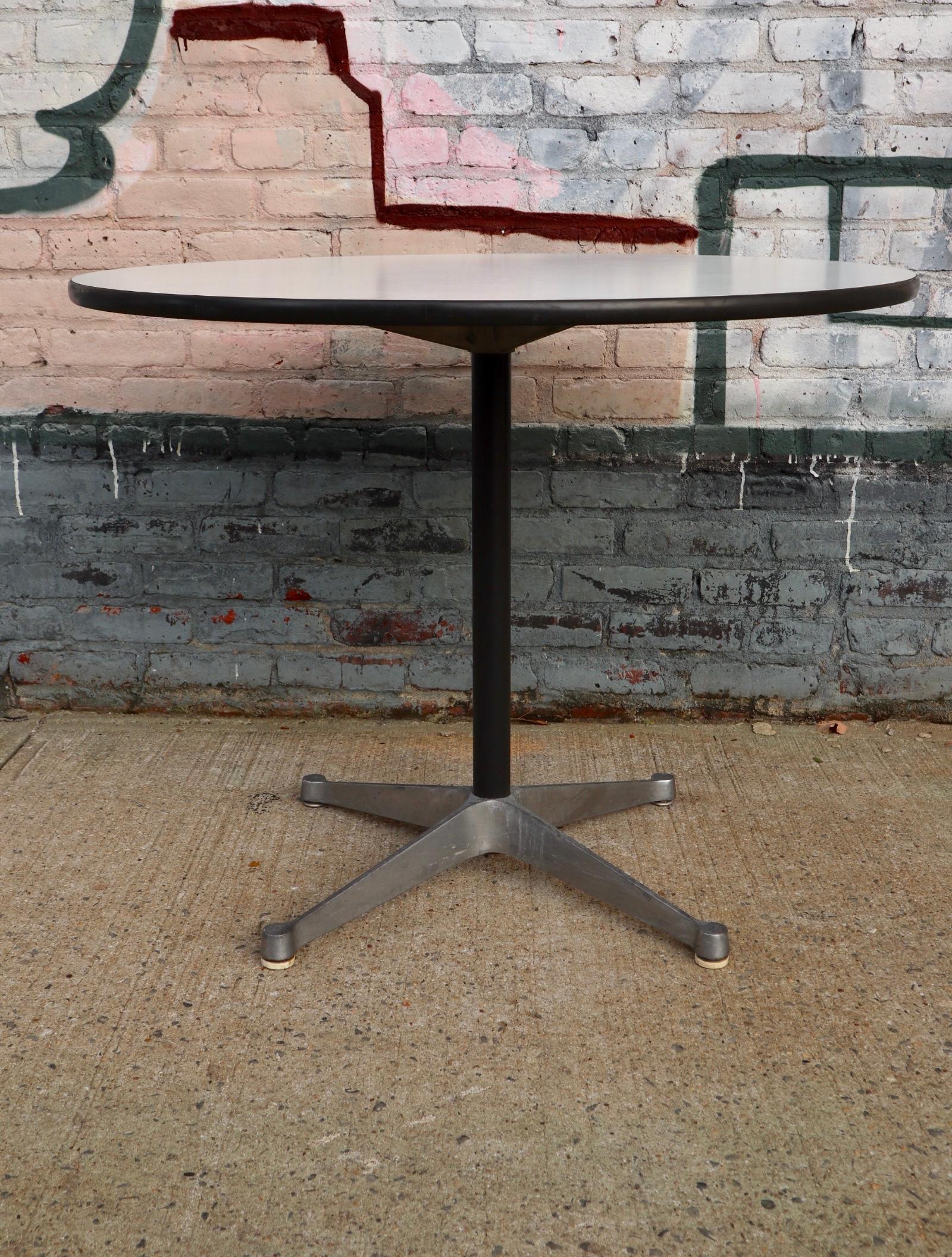 1970s era Herman Miller Eames circular dining table. Measures: 36 inches in diameter. Fits up to 4 chairs.