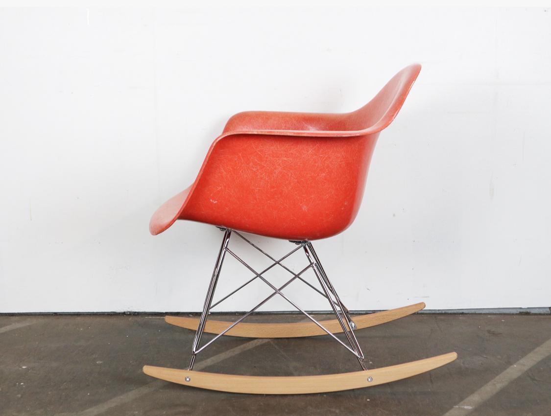 Beautiful Eames rocker. Vintage signed salmon orange shell atop newer steel base with chrome finish and birch runners. No breaks, cracks, or holes. Even color throughout.