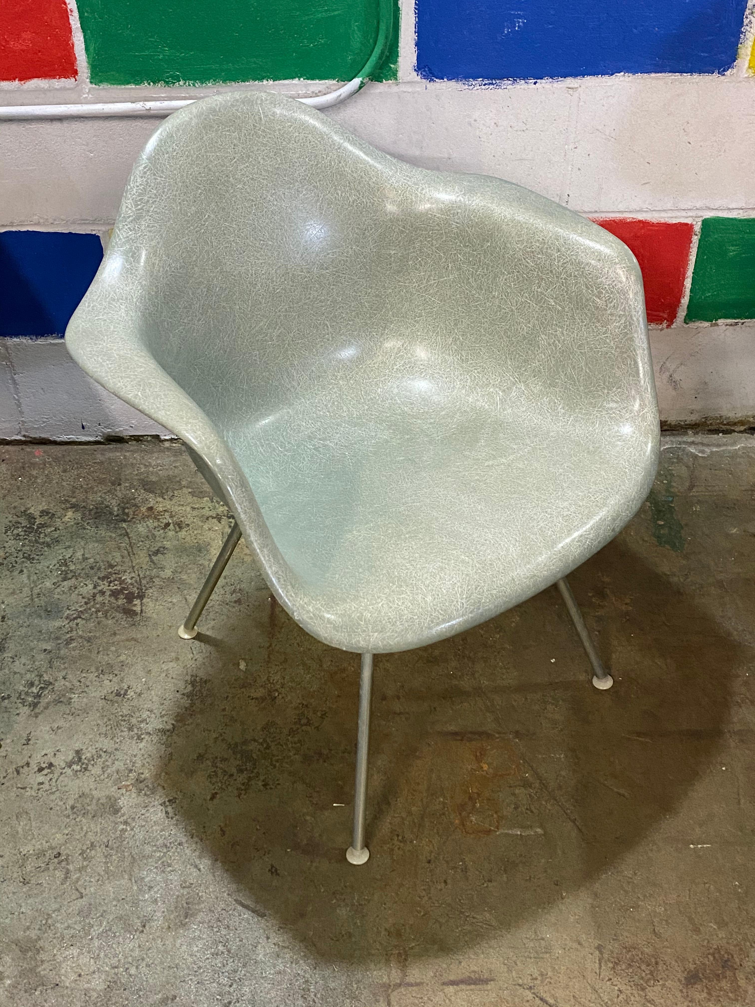 Classic vintage Herman Miller Eames fiberglass chair in the best color, seafoam green. No cracks. Shock mounts intact. Signed and guaranteed authentic. On rate lounge height base. Can swap for dining height base or rocker base. Date stamp of January