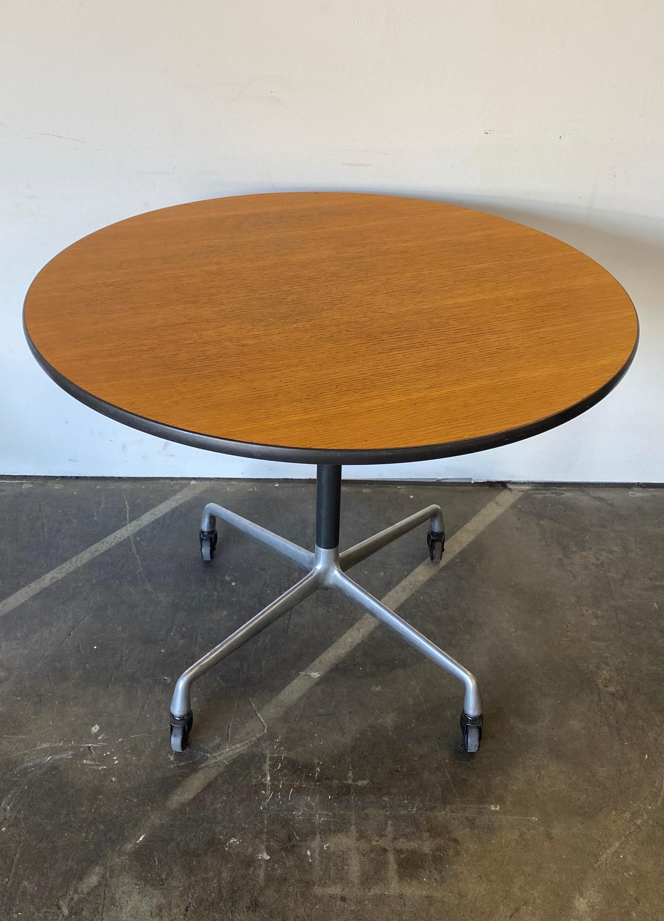 Beautiful dining table design by Charles Andrew Eames and produced by Herman Miller. 36 inches in diameter accommodates up to four dining chairs. Moves freely and easily on original casters. They are rubber for use on a variety of surfaces. Table is