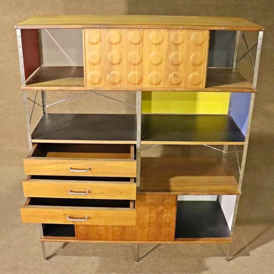 Mid-century standing wall unit with wood grain and colored panels. Sliding door cabinet storage and drawers.
Please confirm location.