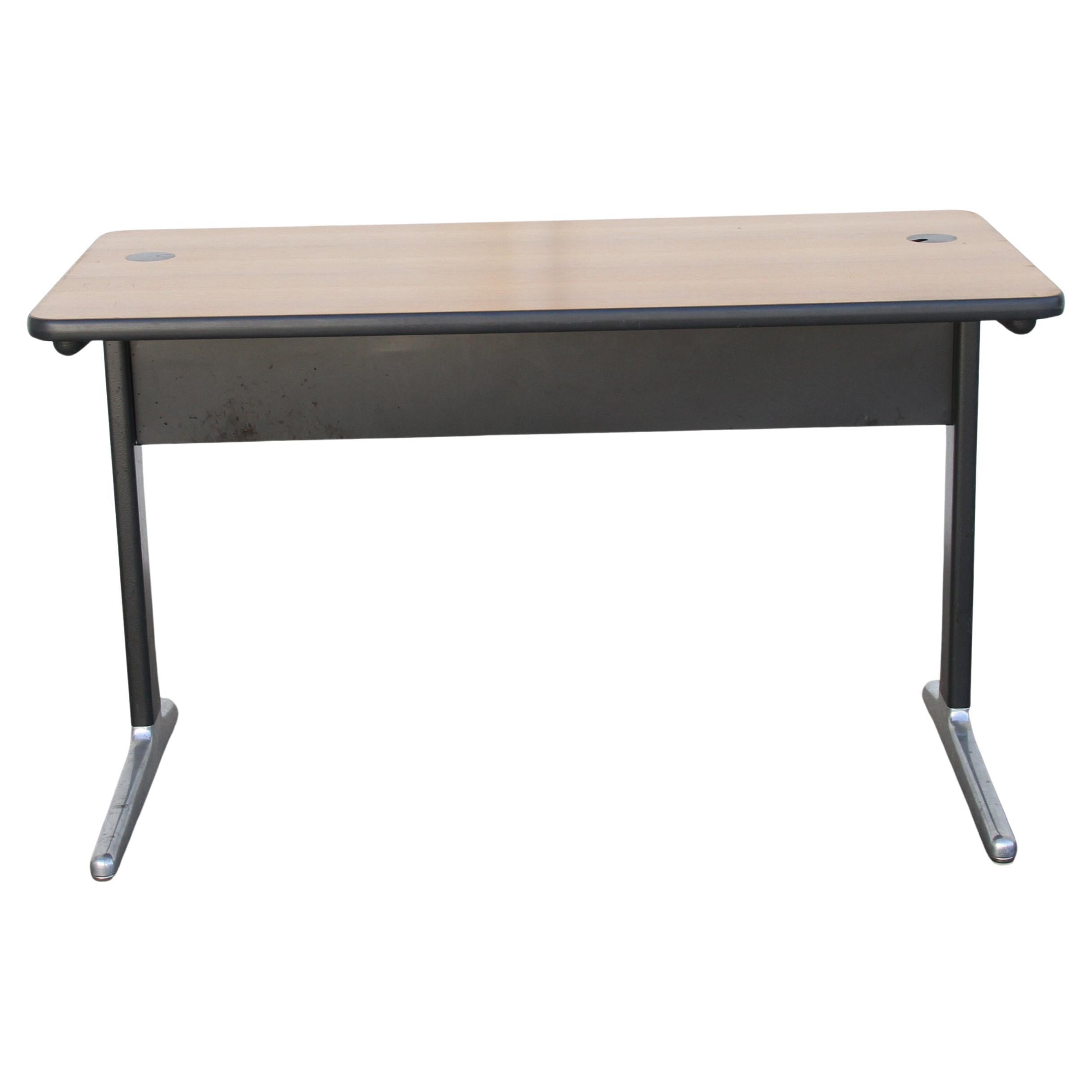 This is a Herman Miller A02 Desk. It was designed by George Nelson and Robert Propst. It has a wood top with steel legs and brush aluminum feet. 
