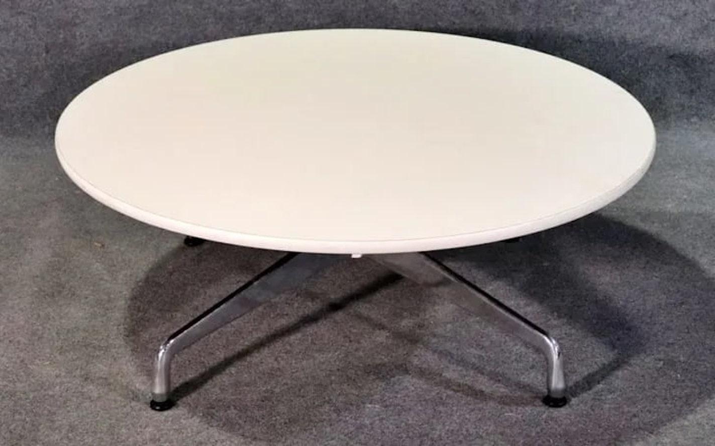 Round coffee table by Eames for Herman Miller. Polished metal base with white laminate top.
Please confirm location NY or NJ