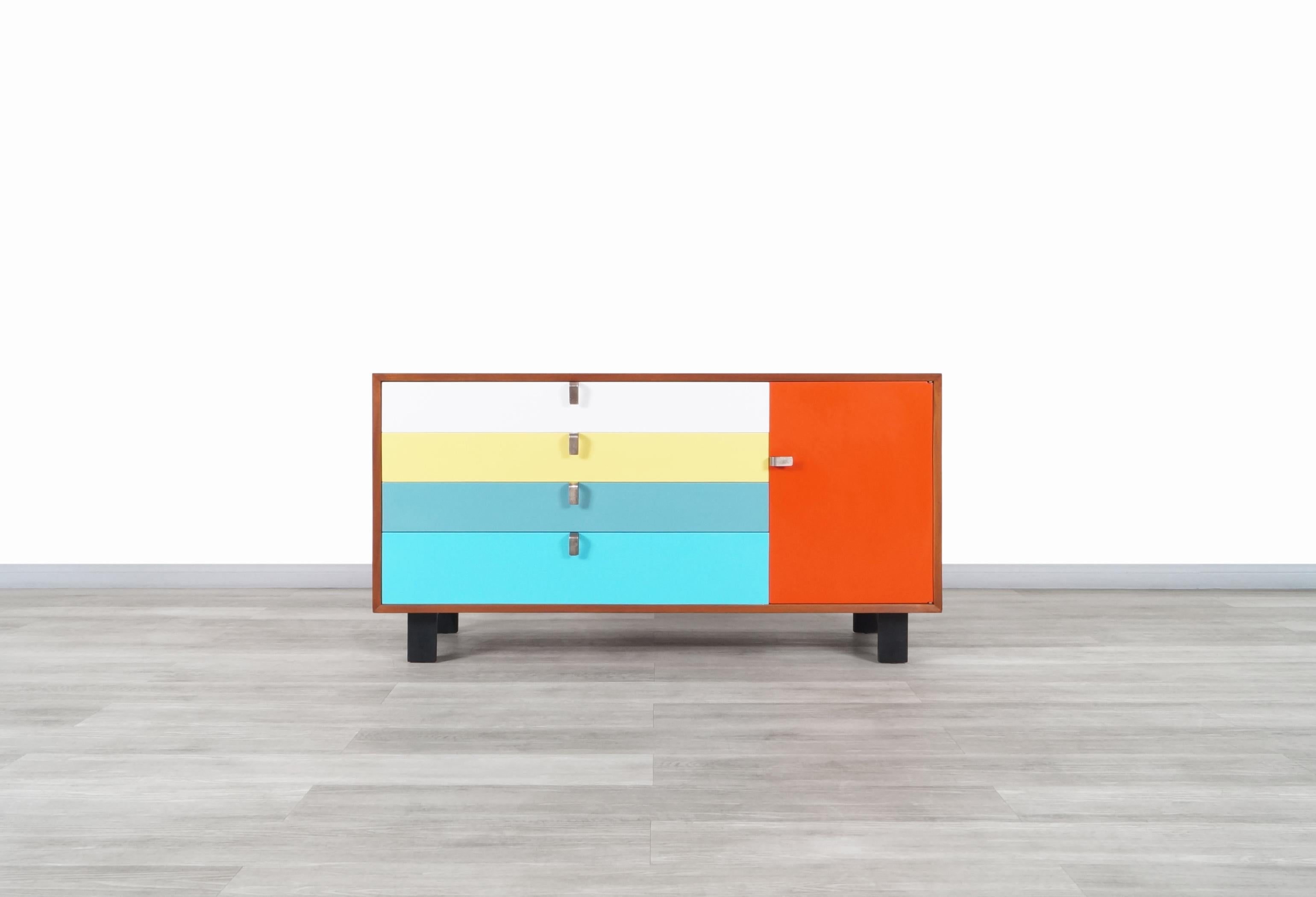 Amazing vintage multi-color lacquered & walnut credenza designed by the iconic designer George Nelson for Herman Miller in the United States, circa 1950s. Features a total of four multi-colored dovetail drawers, which the upper drawer can function